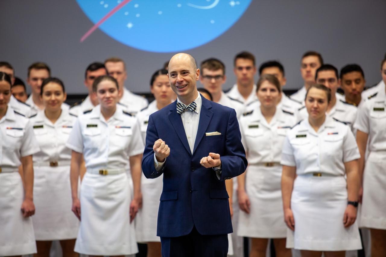 Dr. Aaron Smith, director and chairman, Musical Activities Department, United States Naval Academy, stands in front of the U.S. Naval Academy Glee Club during a performance for Kennedy Space Center employees at the Florida spaceport on March 10, 2020. As part of the celebration, Kennedy Director Bob Cabana discussed the deep historical ties between NASA and the U.S. Navy. The highly acclaimed Glee Club has achieved prominence as one of America’s premier choral ensembles, performing throughout the nation each year.