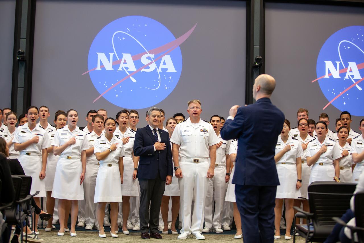 Kennedy Space Center Director Bob Cabana, left, and Captain Ben Shupp, commanding officer, Naval Ordnance Test Unit, stand with the U.S. Naval Academy Glee Club at the Florida spaceport on March 10, 2020. Leading the Glee Club is Dr. Aaron Smith, director and chairman, Musical Activities Department, United States Naval Academy. As part of the special celebration, Cabana discussed the deep historical ties between NASA and the U.S. Navy. The highly acclaimed Glee Club has achieved prominence as one of America’s premier choral ensembles, performing throughout the nation each year.