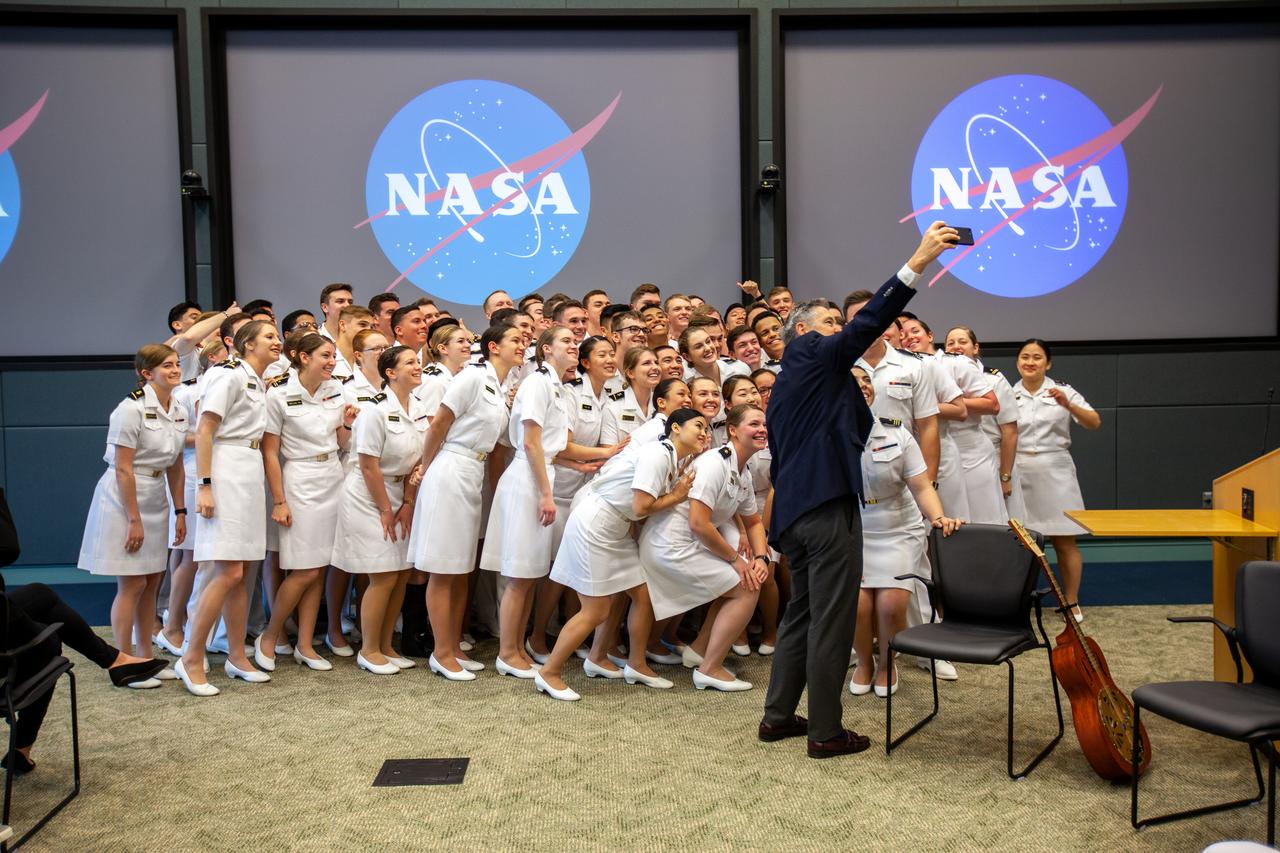 Kennedy Space Center Director Bob Cabana takes a selfie with members of the United States Naval Academy Glee Club at the Florida spaceport on March 10, 2020. The highly acclaimed Glee Club, which performed for Kennedy employees, has achieved prominence as one of America’s premier choral ensembles. As part of the celebration, Cabana discussed the deep historical ties between NASA and the U.S. Navy.