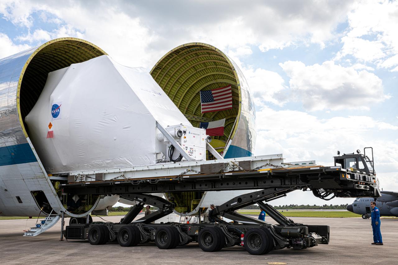 NASA’s Orion spacecraft, protected in its shipping container, is removed from the agency’s Super Guppy aircraft at the Launch and Landing Facility runway at Kennedy Space Center on March 25, 2020, for transportation to the Neil Armstrong Operations and Checkout Building. After testing at NASA’s Plum Brook Station in Ohio verified it can handle the extreme conditions of a deep-space environment, the spacecraft has returned to the Florida spaceport for final testing and assembly. Following this, it will be integrated with the Space Launch System rocket for Artemis I – the first in a series of increasingly complex missions to the Moon that will ultimately lead to the exploration of Mars.