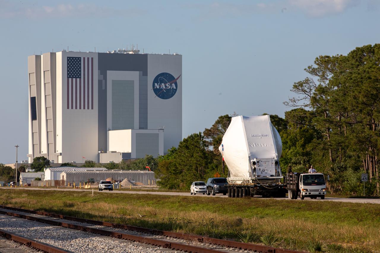 NASA’s Orion spacecraft, protected in its shipping container, is loaded onto a transporter at the Launch and Landing Facility at Kennedy Space Center for its move to the Neil Armstrong Operations and Checkout Building on March 25, 2020. After testing at NASA’s Plum Brook Station in Ohio verified it can handle the extreme conditions of a deep-space environment, the spacecraft – carried by the agency’s Super Guppy aircraft – has returned to the Florida spaceport for final testing and assembly. Following this, Orion will be integrated with the Space Launch System rocket for Artemis I – the first in a series of increasingly complex missions to the Moon that will ultimately lead to the exploration of Mars.