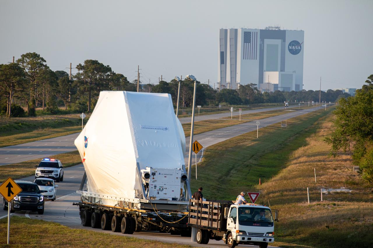 NASA’s Orion spacecraft, protected in its shipping container, is loaded onto a transporter at the Launch and Landing Facility at Kennedy Space Center for its move to the Neil Armstrong Operations and Checkout Building on March 25, 2020. After testing at NASA’s Plum Brook Station in Ohio verified it can handle the extreme conditions of a deep-space environment, the spacecraft – carried by the agency’s Super Guppy aircraft – has returned to the Florida spaceport for final testing and assembly. Following this, Orion will be integrated with the Space Launch System rocket for Artemis I – the first in a series of increasingly complex missions to the Moon that will ultimately lead to the exploration of Mars.
