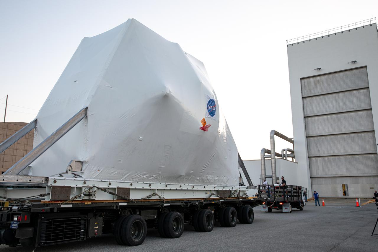 The Orion spacecraft, secured atop a transporter in its shipping container, arrives at the Neil Armstrong Operations and Checkout Building at NASA’s Kennedy Space Center in Florida on March 25, 2020, for final testing and assembly. The spacecraft was transported to Kennedy in NASA’s Super Guppy aircraft from the agency’s Plum Brook Station in Ohio, where it underwent two phase of environmental testing. Following these final preparations, Orion will be integrated with the Space Launch System rocket for the Artemis I launch – the first in a series of increasingly complex missions to the Moon that will ultimately lead to the exploration of Mars.