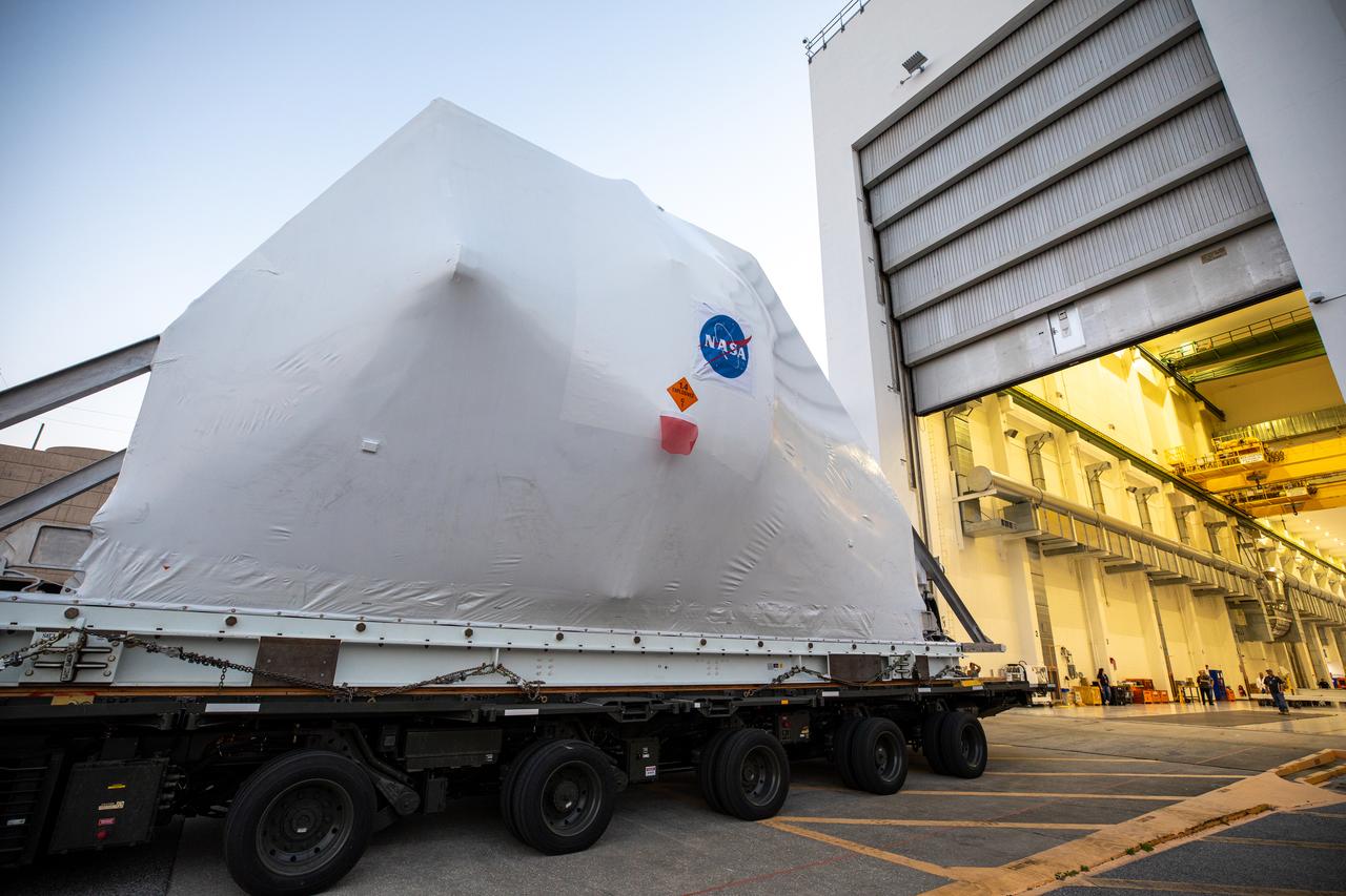 The Orion spacecraft, secured atop a transporter in its shipping container, arrives at the Neil Armstrong Operations and Checkout Building at NASA’s Kennedy Space Center in Florida on March 25, 2020, for final testing and assembly. The spacecraft was transported to Kennedy in NASA’s Super Guppy aircraft from the agency’s Plum Brook Station in Ohio, where it underwent two phase of environmental testing. Following these final preparations, Orion will be integrated with the Space Launch System rocket for the Artemis I launch – the first in a series of increasingly complex missions to the Moon that will ultimately lead to the exploration of Mars.