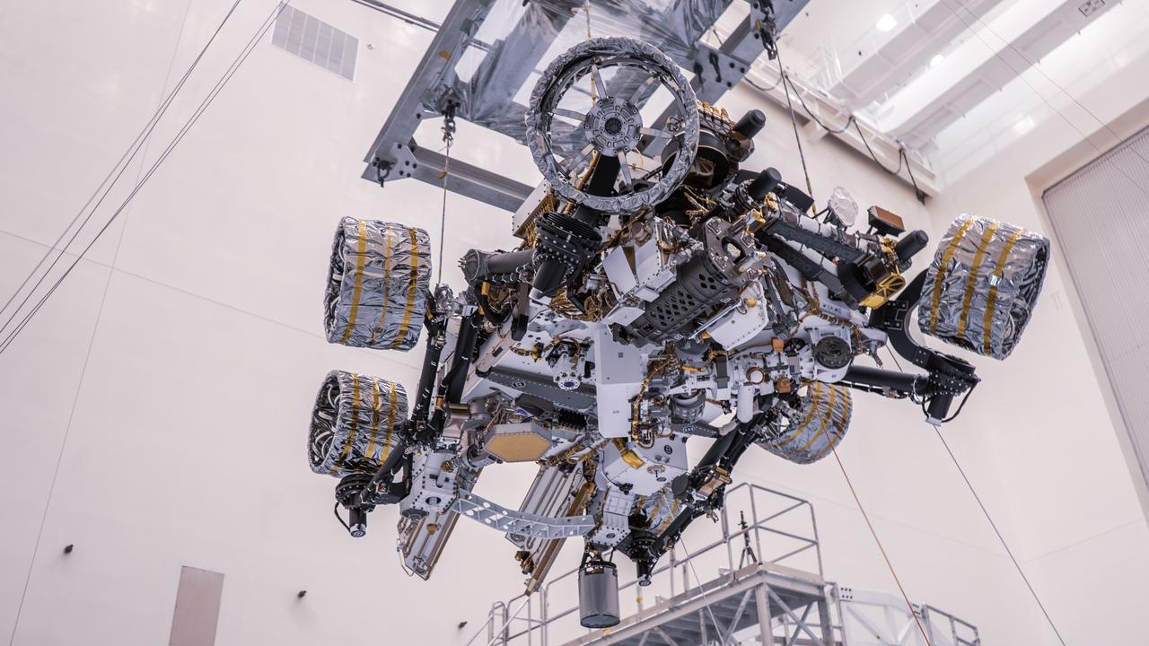 Engineers perform mass properties testing on NASA’s Mars Perseverance rover inside Kennedy Space Center’s Payload Hazardous Servicing Facility on April 7, 2020. The rover was rotated clockwise and counterclockwise on a spin table to determine the center of gravity, or the point at which weight is evenly dispersed on all sides. Establishing the rover’s center of gravity will help ensure the spacecraft will land on Mars as calculated. Perseverance will touch down on the Red Planet on Feb. 18, 2021. Liftoff aboard a United Launch Alliance Atlas V 541 rocket is targeted between July 17 and Aug. 5 from Cape Canaveral Air Force Station. NASA’s Launch Services Program based at Kennedy is managing the launch.