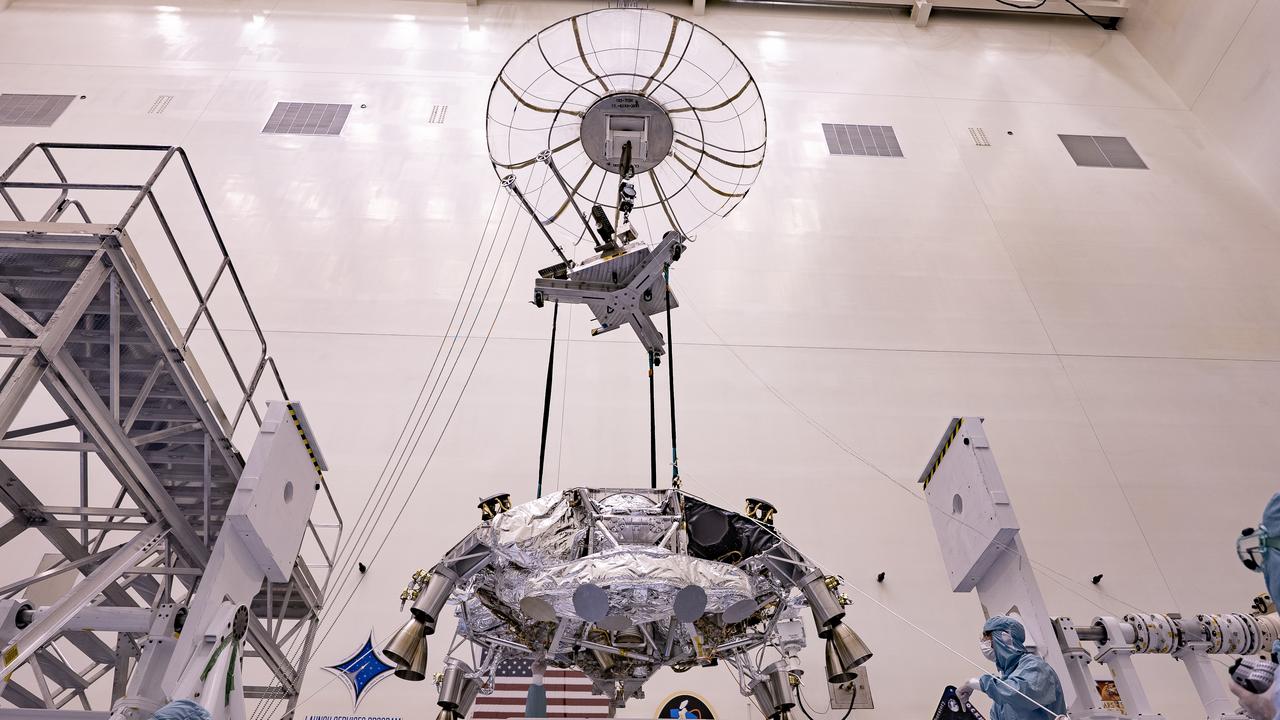 Engineers perform mass properties testing on the rocket-powered descent stage of NASA’s Mars Perseverance rover at Kennedy Space Center on April 9, 2020. The testing to determine the center of gravity, or the point at which weight is evenly dispersed on all sides, was performed inside the Florida spaceport’s Payload Hazardous Servicing Facility. The descent stage will lower the rover through the thin Martian atmosphere and onto the surface on Feb. 18, 2021. Liftoff, aboard a United Launch Alliance Atlas V 541 rocket, is targeted between July 17 and Aug. 5 from Cape Canaveral Air Force Station. NASA’s Launch Services Program based at Kennedy is managing the launch. The rover will seek signs of ancient life and collect rock and soil samples for possible return to Earth.