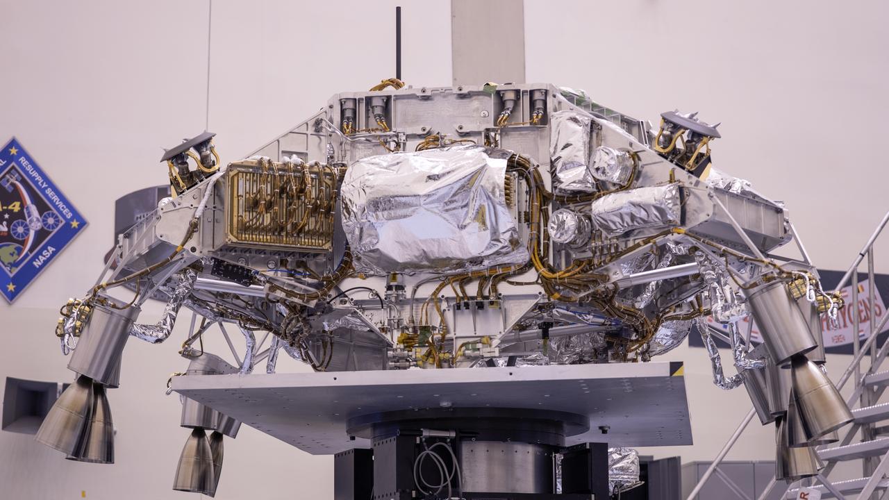 Engineers perform mass properties testing on the rocket-powered descent stage of NASA’s Mars Perseverance rover at Kennedy Space Center on April 12, 2020. The testing to determine the center of gravity, or the point at which weight is evenly dispersed on all sides, was performed inside the Florida spaceport’s Payload Hazardous Servicing Facility. The descent stage will lower the rover through the thin Martian atmosphere and onto the surface on Feb. 18, 2021. Liftoff, aboard a United Launch Alliance Atlas V 541 rocket, is targeted between July 17 and Aug. 5 from Cape Canaveral Air Force Station. NASA’s Launch Services Program based at Kennedy is managing the launch. The rover will seek signs of ancient life and collect rock and soil samples for possible return to Earth.
