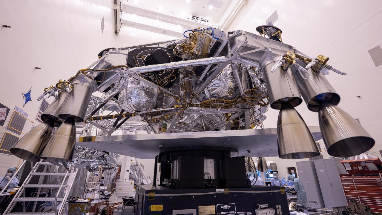 Engineers perform mass properties testing on the rocket-powered descent stage of NASA’s Mars Perseverance rover at Kennedy Space Center on April 12, 2020. The testing to determine the center of gravity, or the point at which weight is evenly dispersed on all sides, was performed inside the Florida spaceport’s Payload Hazardous Servicing Facility. The descent stage will lower the rover through the thin Martian atmosphere and onto the surface on Feb. 18, 2021. Liftoff, aboard a United Launch Alliance Atlas V 541 rocket, is targeted between July 17 and Aug. 5 from Cape Canaveral Air Force Station. NASA’s Launch Services Program based at Kennedy is managing the launch. The rover will seek signs of ancient life and collect rock and soil samples for possible return to Earth.