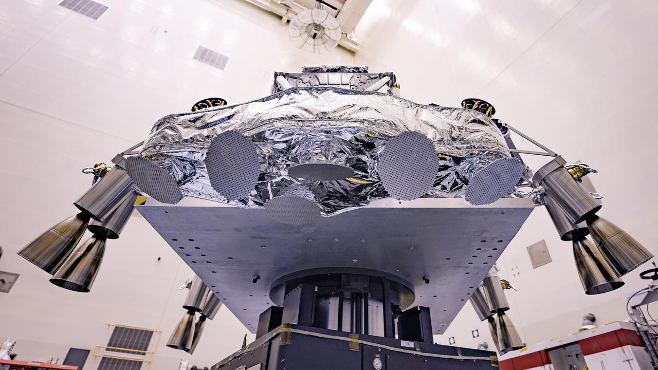 Engineers perform mass properties testing on the rocket-powered descent stage of NASA’s Mars Perseverance rover at Kennedy Space Center on April 12, 2020. The testing to determine the center of gravity, or the point at which weight is evenly dispersed on all sides, was performed inside the Florida spaceport’s Payload Hazardous Servicing Facility. The descent stage will lower the rover through the thin Martian atmosphere and onto the surface on Feb. 18, 2021. Liftoff, aboard a United Launch Alliance Atlas V 541 rocket, is targeted between July 17 and Aug. 5 from Cape Canaveral Air Force Station. NASA’s Launch Services Program based at Kennedy is managing the launch. The rover will seek signs of ancient life and collect rock and soil samples for possible return to Earth.