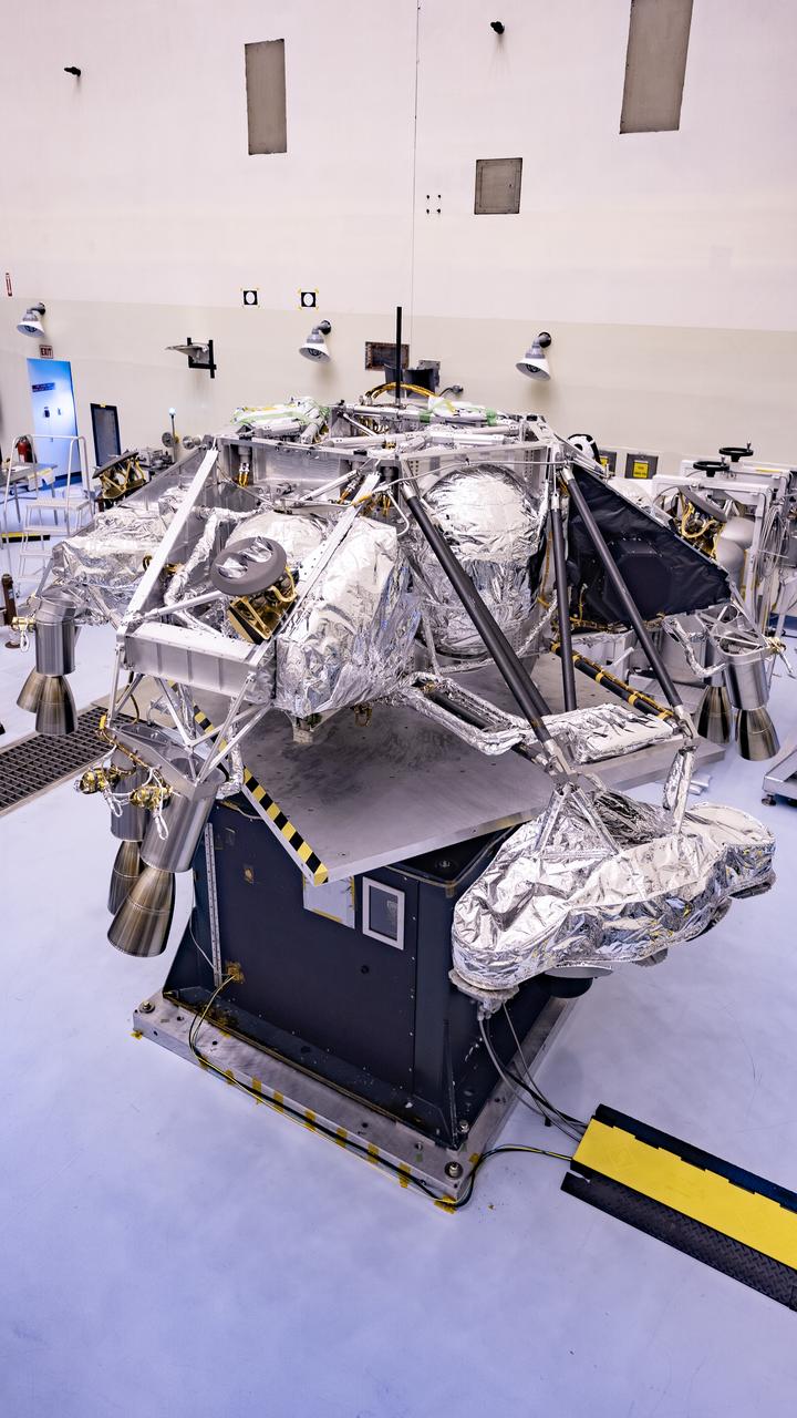 Engineers perform mass properties testing on the rocket-powered descent stage of NASA’s Mars Perseverance rover at Kennedy Space Center on April 12, 2020. The testing to determine the center of gravity, or the point at which weight is evenly dispersed on all sides, was performed inside the Florida spaceport’s Payload Hazardous Servicing Facility. The descent stage will lower the rover through the thin Martian atmosphere and onto the surface on Feb. 18, 2021. Liftoff, aboard a United Launch Alliance Atlas V 541 rocket, is targeted between July 17 and Aug. 5 from Cape Canaveral Air Force Station. NASA’s Launch Services Program based at Kennedy is managing the launch. The rover will seek signs of ancient life and collect rock and soil samples for possible return to Earth.