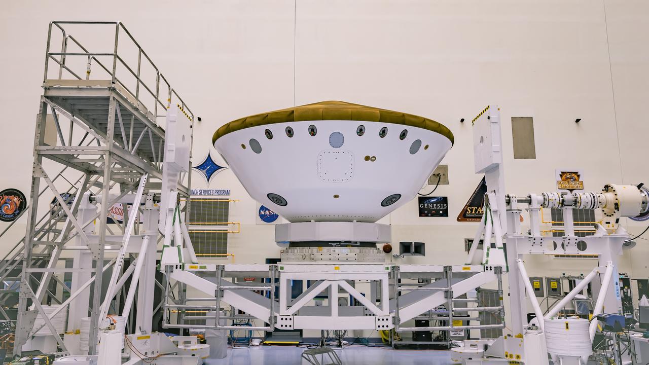 Inside the Payload Hazardous Servicing Facility at NASA’s Kennedy Space Center in Florida, the Backshell-Powered Descent Vehicle and Entry Vehicle assemblies are attached to the Mars Perseverance rover on May 6, 2020. The cone-shaped backshell contains the parachute, and along with the mission’s heat shield, provides protection for the rover and descent stage during Martian atmospheric entry. The Mars Perseverance rover is scheduled to launch in mid-July atop a United Launch Alliance Atlas V 541 rocket from Pad 41 at nearby Cape Canaveral Air Force Station. The rover is part of NASA’s Mars Exploration Program, a long-term effort of robotic exploration of the Red Planet. The rover will search for habitable conditions in the ancient past and signs of past microbial life on Mars. The Launch Services Program at Kennedy is responsible for launch management.