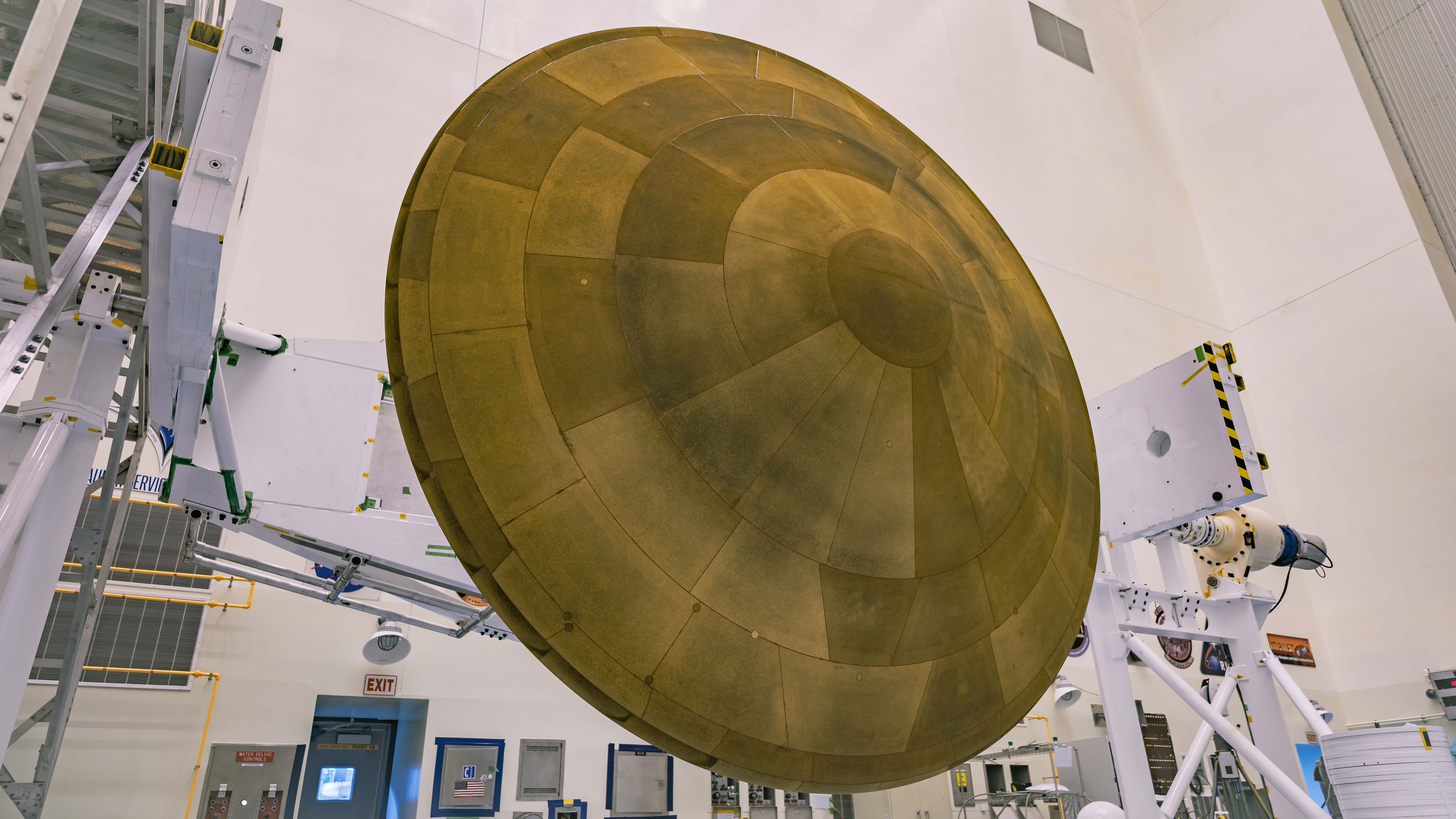 Inside the Payload Hazardous Servicing Facility at NASA’s Kennedy Space Center in Florida, the Backshell-Powered Descent Vehicle and Entry Vehicle assemblies are attached to the Mars Perseverance rover on May 6, 2020. The cone-shaped backshell contains the parachute, and along with the mission’s heat shield, provides protection for the rover and descent stage during Martian atmospheric entry. The Mars Perseverance rover is scheduled to launch in mid-July atop a United Launch Alliance Atlas V 541 rocket from Pad 41 at nearby Cape Canaveral Air Force Station. The rover is part of NASA’s Mars Exploration Program, a long-term effort of robotic exploration of the Red Planet. The rover will search for habitable conditions in the ancient past and signs of past microbial life on Mars. The Launch Services Program at Kennedy is responsible for launch management.