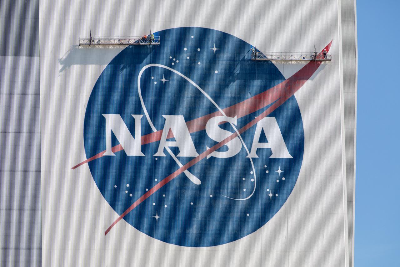 Painting of the NASA logo, also called the meatball, is underway on the 525-foot-tall Vehicle Assembly Building (VAB) at the agency’s Kennedy Space Center in Florida on May 8, 2020. HM2 and H.I.S. Painting of Titusville, Florida, are repainting the meatball and the American Flag on the iconic building. High Bay 3 inside the VAB has been upgraded with 10 new levels of work platforms that will surround and provide access for service and processing of NASA's Space Launch System (SLS) rocket and Orion spacecraft. Exploration Ground Systems is overseeing upgrades to the VAB to support the launch of the SLS and Orion for Artemis missions. Under the Artemis program, NASA will send the first woman and next man to the Moon.