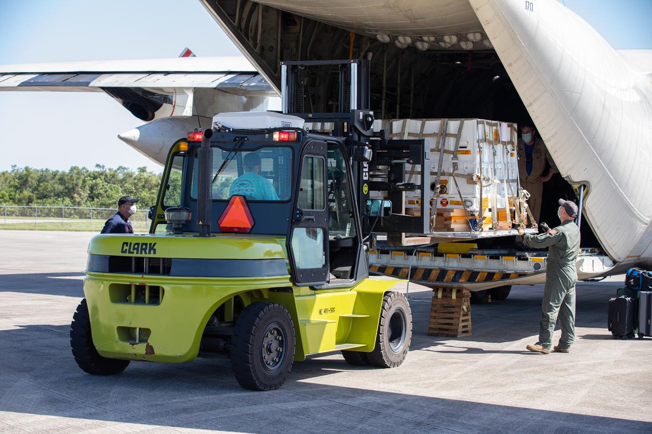 Workers offload the Adaptive Caching Assembly (ACA) for NASA’s Mars Perseverance rover from the agency’s C-130 aircraft at Kennedy Space Center’s Launch and Landing Facility in Florida on May 11, 2020. The ACA consists of seven motors and more than 3,000 parts, all working in unison to collect samples from the surface of Mars. A chief component of the assembly is the Sample Handling Arm, which will move sample tubes to the main robotic arm's coring drill and then transfer the filled sample tubes into a space to be sealed and stored. The Mars Perseverance rover is scheduled to launch in mid-July atop a United Launch Alliance Atlas V 541 rocket from Pad 41 at nearby Cape Canaveral Air Force Station. The rover is part of NASA’s Mars Exploration Program, a long-term effort of robotic exploration of the Red Planet. The rover will search for habitable conditions in the ancient past and signs of past microbial life on Mars. The Launch Services Program at Kennedy is responsible for launch management. 