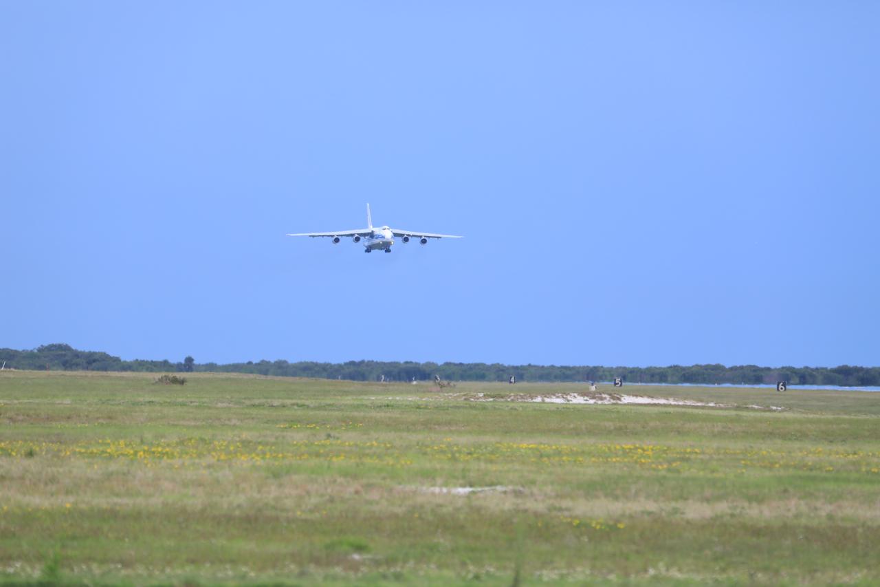 The Antonov 124 cargo aircraft, carrying the United Launch Alliance booster for NASA’s Mars Perseverance rover, descends toward the Skid Strip at Cape Canaveral Air Force Station (CCAFS) in Florida on May 18, 2020. The Mars Perseverance rover is scheduled to launch in mid-July atop a United Launch Alliance Atlas V 541 rocket from Pad 41 at CCAFS. The rover is part of NASA’s Mars Exploration Program, a long-term effort of robotic exploration of the Red Planet. The rover will search for habitable conditions in the ancient past and signs of past microbial life on Mars. The Launch Services Program at Kennedy is responsible for launch management.