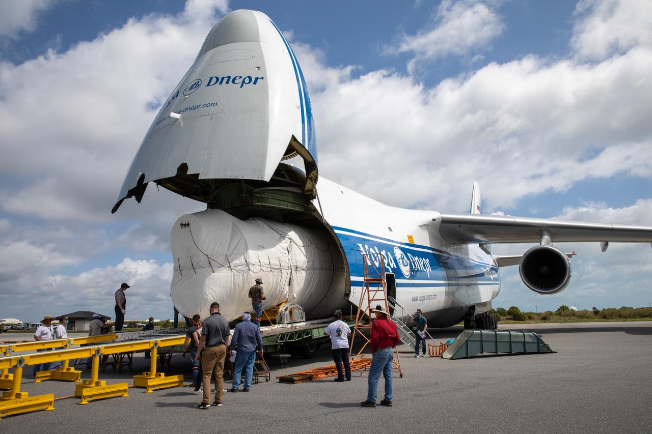 Workers help offload the United Launch Alliance booster for NASA’s Mars Perseverance rover from the Antonov 124 cargo aircraft at the Skid Strip at Cape Canaveral Air Force Station (CCAFS) in Florida on May 19, 2020. The Mars Perseverance rover is scheduled to launch in mid-July atop a United Launch Alliance Atlas V 541 rocket from Pad 41 at CCAFS. The rover is part of NASA’s Mars Exploration Program, a long-term effort of robotic exploration of the Red Planet. The rover will search for habitable conditions in the ancient past and signs of past microbial life on Mars. The Launch Services Program at Kennedy is responsible for launch management.