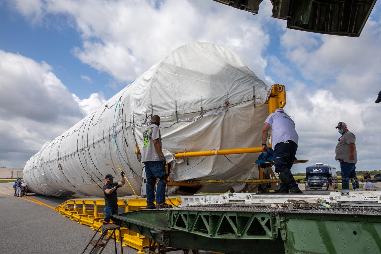 Workers secure the United Launch Alliance booster for NASA’s Mars Perseverance rover as it is offloaded from the Antonov 124 cargo aircraft at the Skid Strip at Cape Canaveral Air Force Station (CCAFS) in Florida on May 19, 2020. The Mars Perseverance rover is scheduled to launch in mid-July atop a United Launch Alliance Atlas V 541 rocket from Pad 41 at CCAFS. The rover is part of NASA’s Mars Exploration Program, a long-term effort of robotic exploration of the Red Planet. The rover will search for habitable conditions in the ancient past and signs of past microbial life on Mars. The Launch Services Program at Kennedy is responsible for launch management.
