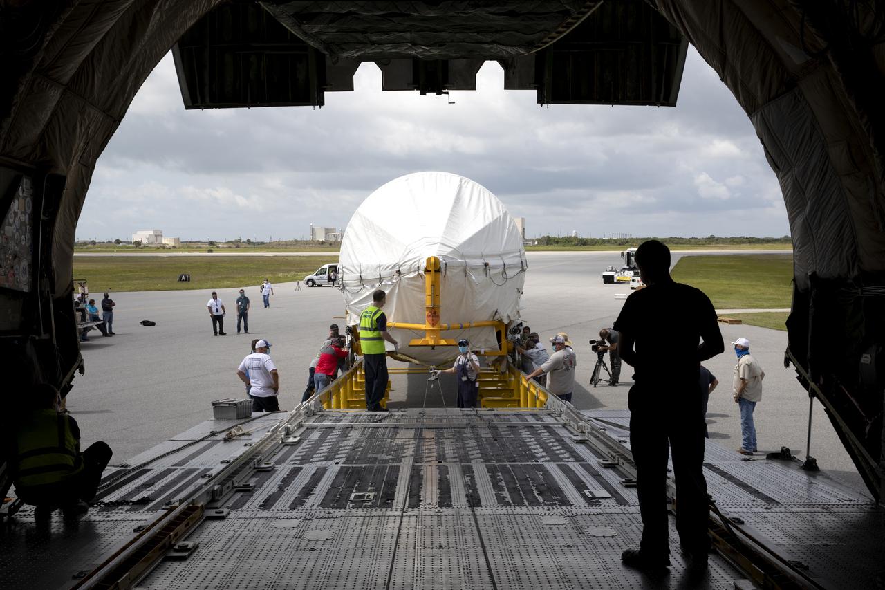 In this view from inside the Antonov 124 cargo aircraft, the United Launch Alliance booster for NASA’s Mars Perseverance rover is offloaded at the Skid Strip at Cape Canaveral Air Force Station (CCAFS) in Florida on May 19, 2020. The Mars Perseverance rover is scheduled to launch in mid-July atop a United Launch Alliance Atlas V 541 rocket from Pad 41 at CCAFS. The rover is part of NASA’s Mars Exploration Program, a long-term effort of robotic exploration of the Red Planet. The rover will search for habitable conditions in the ancient past and signs of past microbial life on Mars. The Launch Services Program at Kennedy is responsible for launch management. 