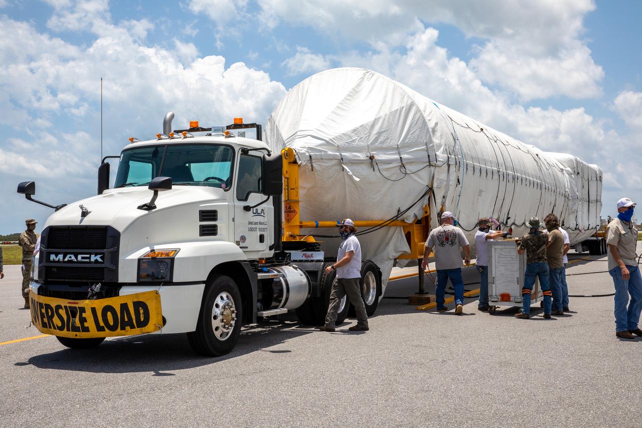 The United Launch Alliance booster for NASA’s Mars Perseverance rover is secured on a flatbed truck after being offloaded from the Antonov 124 cargo aircraft at the Skid Strip at Cape Canaveral Air Force Station (CCAFS) in Florida on May 19, 2020. The Mars Perseverance rover is scheduled to launch in mid-July atop a United Launch Alliance Atlas V 541 rocket from Pad 41 at CCAFS. The rover is part of NASA’s Mars Exploration Program, a long-term effort of robotic exploration of the Red Planet. The rover will search for habitable conditions in the ancient past and signs of past microbial life on Mars. The Launch Services Program at Kennedy is responsible for launch management.