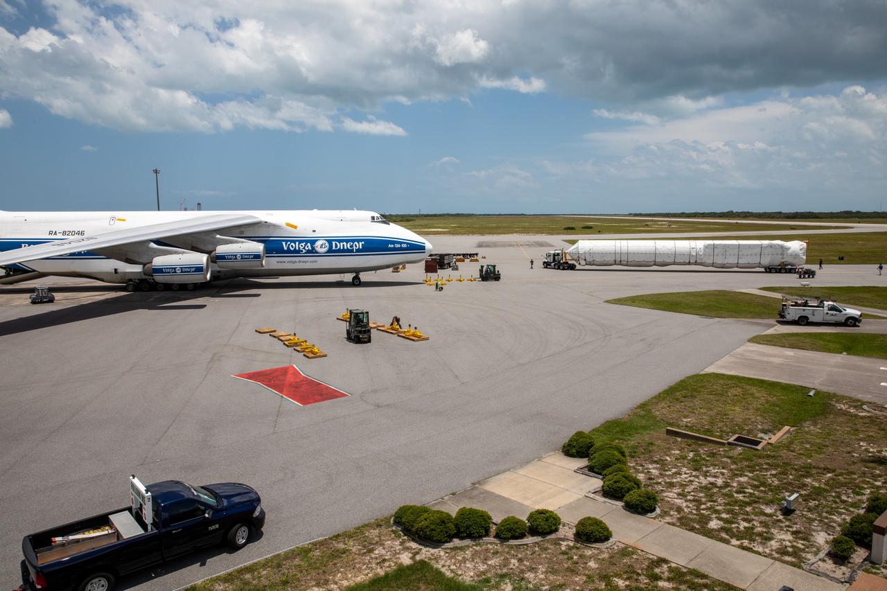 The United Launch Alliance booster for NASA’s Mars Perseverance rover is secured on a flatbed truck after being offloaded from the Antonov 124 cargo aircraft at the Skid Strip at Cape Canaveral Air Force Station (CCAFS) in Florida on May 19, 2020. The Mars Perseverance rover is scheduled to launch in mid-July atop a United Launch Alliance Atlas V 541 rocket from Pad 41 at CCAFS. The rover is part of NASA’s Mars Exploration Program, a long-term effort of robotic exploration of the Red Planet. The rover will search for habitable conditions in the ancient past and signs of past microbial life on Mars. The Launch Services Program at Kennedy is responsible for launch management.