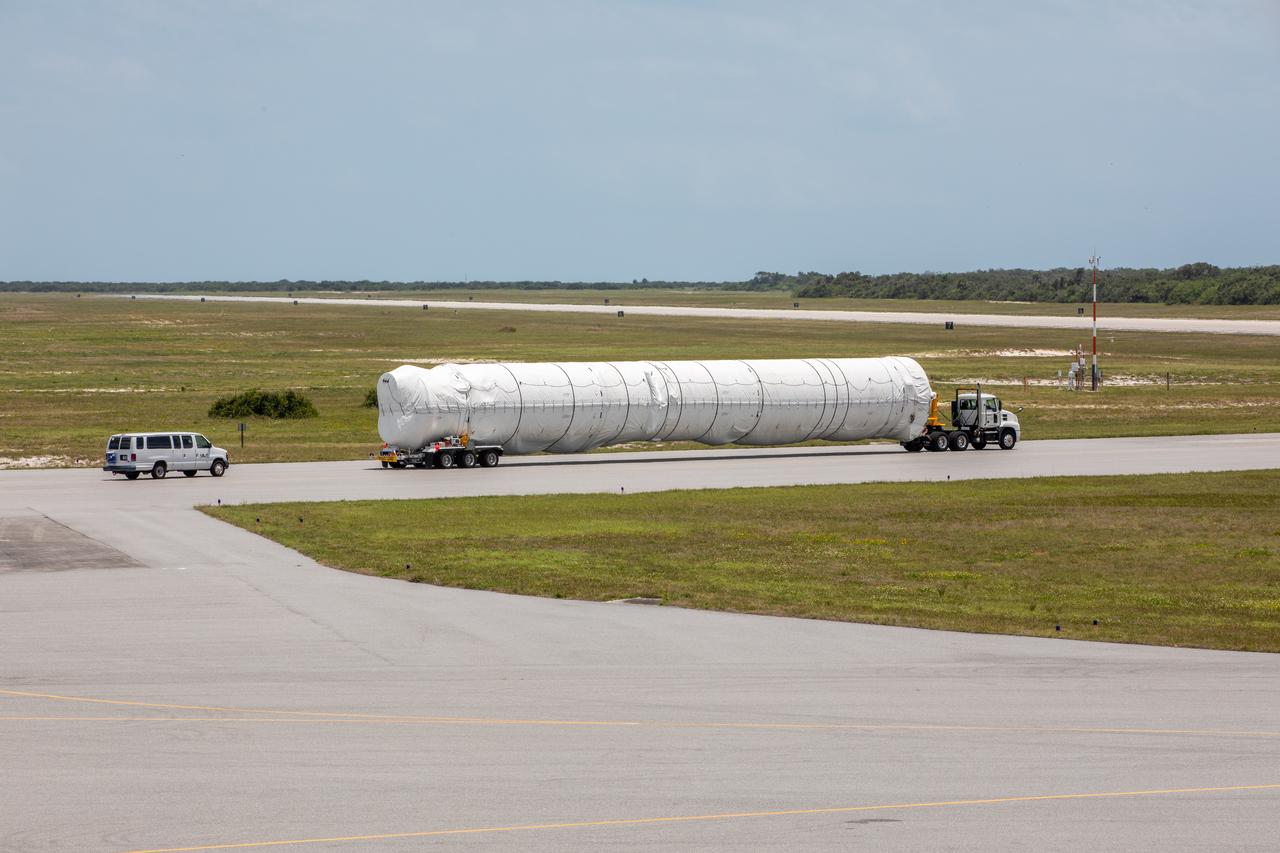 A flatbed truck carrying the United Launch Alliance booster for NASA’s Mars Perseverance rover departs the Skid Strip at Cape Canaveral Air Force Station (CCAFS) in Florida on May 19, 2020. The booster arrived aboard the Antonov 124 cargo aircraft at the Skid Strip on May 18, 2020. The Mars Perseverance rover is scheduled to launch in mid-July atop a United Launch Alliance Atlas V 541 rocket from Pad 41 at CCAFS. The rover is part of NASA’s Mars Exploration Program, a long-term effort of robotic exploration of the Red Planet. The rover will search for habitable conditions in the ancient past and signs of past microbial life on Mars. The Launch Services Program at Kennedy is responsible for launch management.