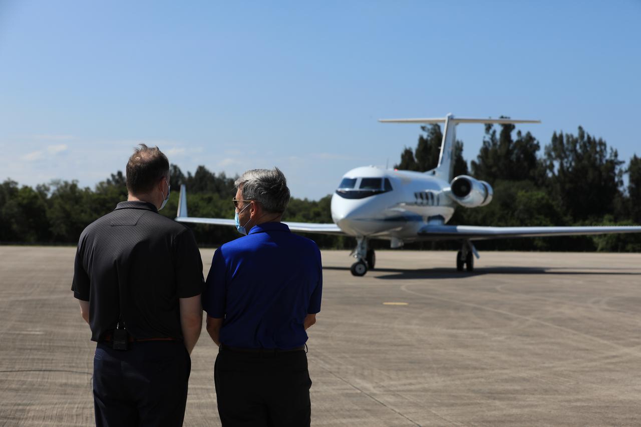 NASA Administrator Jim Bridenstine (left) and Kennedy Space Center Director Bob Cabana watch as the Gulfstream jet, carrying NASA astronauts Robert Behnken and Douglas Hurley, who will fly on the agency’s SpaceX Demo-2 mission to the International Space Station, lands at the Launch and Landing Facility runway at the Florida spaceport on May 20, 2020. Under NASA’s Commercial Crew Program, Behnken and Hurley will be the first astronauts to launch to the orbiting laboratory from U.S. soil since the end of the Space Shuttle Program in 2011. Liftoff of the SpaceX Falcon 9 rocket and Crew Dragon spacecraft is scheduled for 4:33 p.m. on May 27 from Kennedy’s Launch Complex 39A.