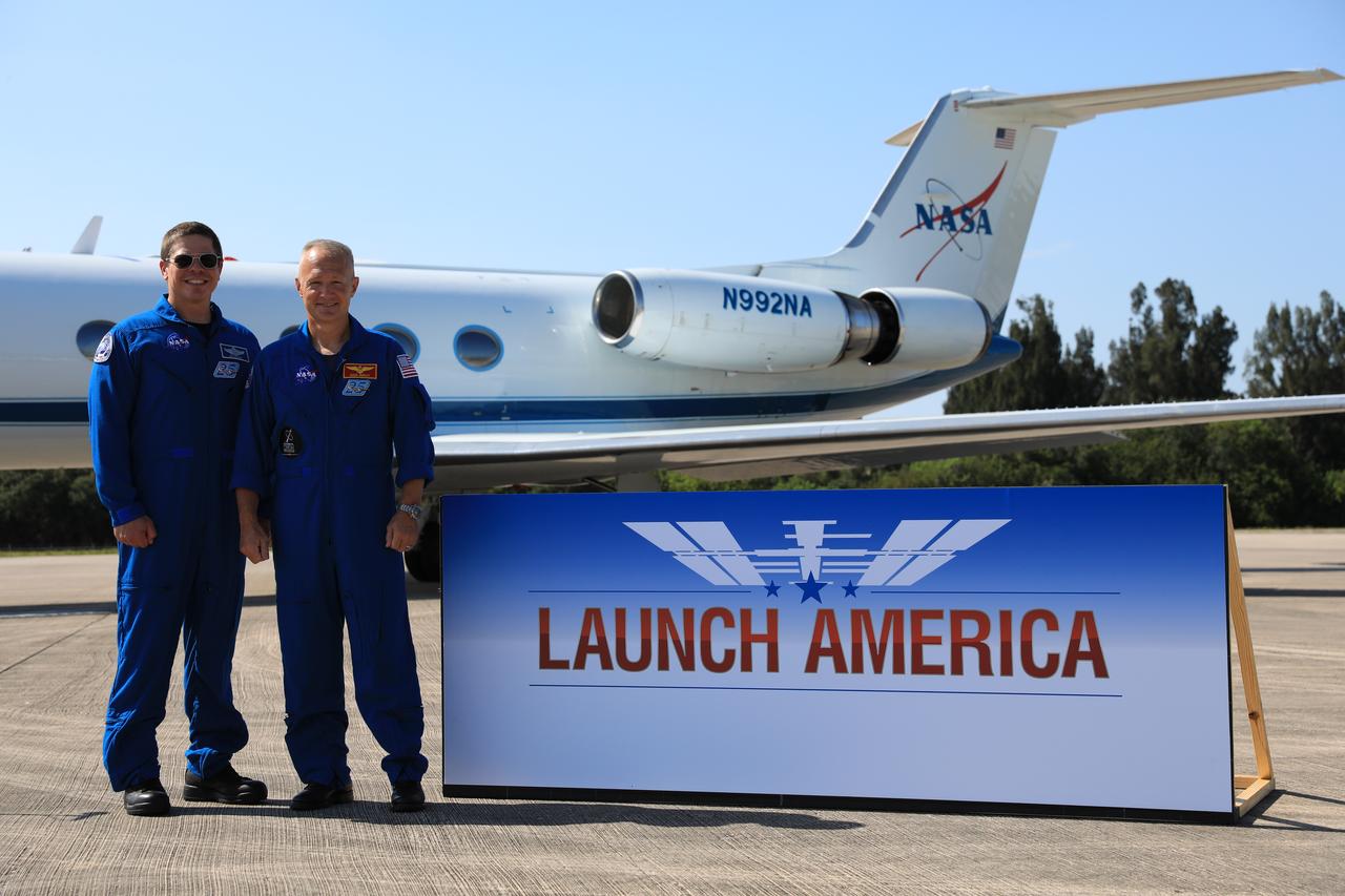 From left, Demo-2 crew members Robert Behnken and Douglas Hurley pose for a photo after speaking to members of the media on May 20, 2020, at the Launch and Landing Facility runway following the crew’s arrival to the Florida spaceport. Under NASA’s Commercial Crew Program, Behnken and Hurley will be the first astronauts launching to the International Space Station from U.S. soil since the end of the Space Shuttle Program in 2011. Liftoff of the SpaceX Falcon 9 rocket and Crew Dragon spacecraft is scheduled for 4:33 p.m. on May 27 from Kennedy’s Launch Complex 39A.