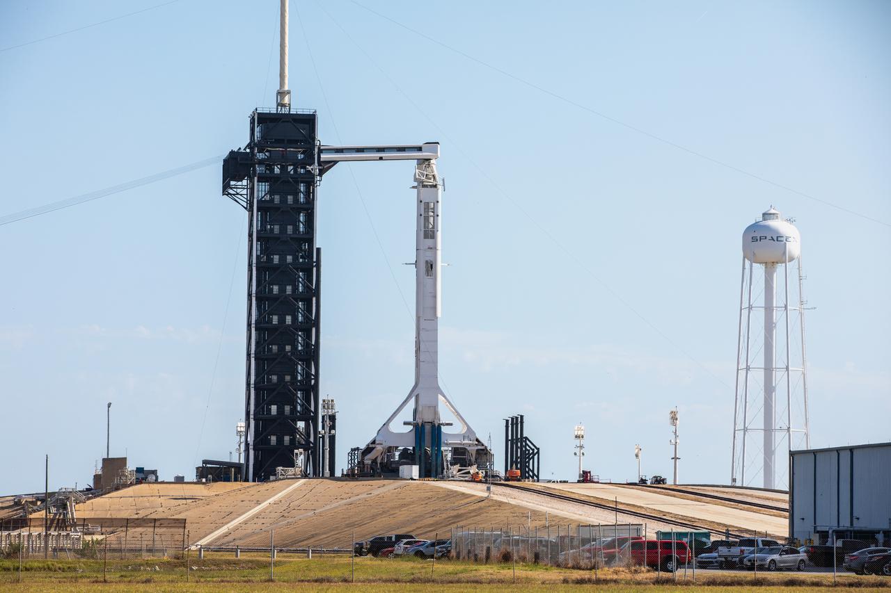 SpaceX’s Crew Dragon spacecraft, atop the company’s Falcon 9 rocket, stands poised at the pad at historic Launch Complex 39A at NASA’s Kennedy Space Center in Florida on May 21, 2020, ahead of NASA’s SpaceX Demo-2 launch. The rocket and spacecraft will carry NASA astronauts Robert Behnken and Douglas Hurley to the International Space Station as part of the agency’s Commercial Crew Program, returning human spaceflight capability to the U.S. after nearly a decade. This will be SpaceX’s final flight test, paving the way for NASA to certify the crew transportation system for regular, crewed flights to the orbiting laboratory. Launch is slated for 4:33 p.m. EDT on Wednesday, May 27.