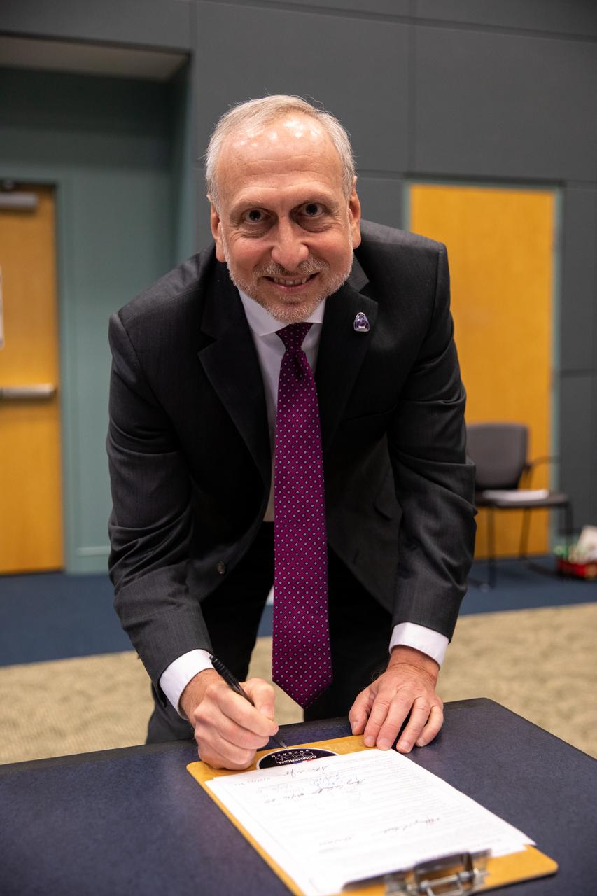 On May 22, 2020, inside the Operations Support Building II at NASA’s Kennedy Space Center in Florida, NASA Associate Administrator Steve Jurczyk signs the official document denoting the agency and SpaceX are a ‘Go’ for the upcoming Demo-2 launch, following the conclusion of the flight readiness review. A SpaceX Falcon 9 rocket and Crew Dragon spacecraft will carry NASA astronauts Robert Behnken and Douglas Hurley to the International Space Station as part of the agency’s Commercial Crew Program, returning human spaceflight capability to the U.S. after nearly a decade. Launch is slated for 4:33 p.m. EDT on Wednesday, May 27, from Kennedy’s Launch Complex 39A.