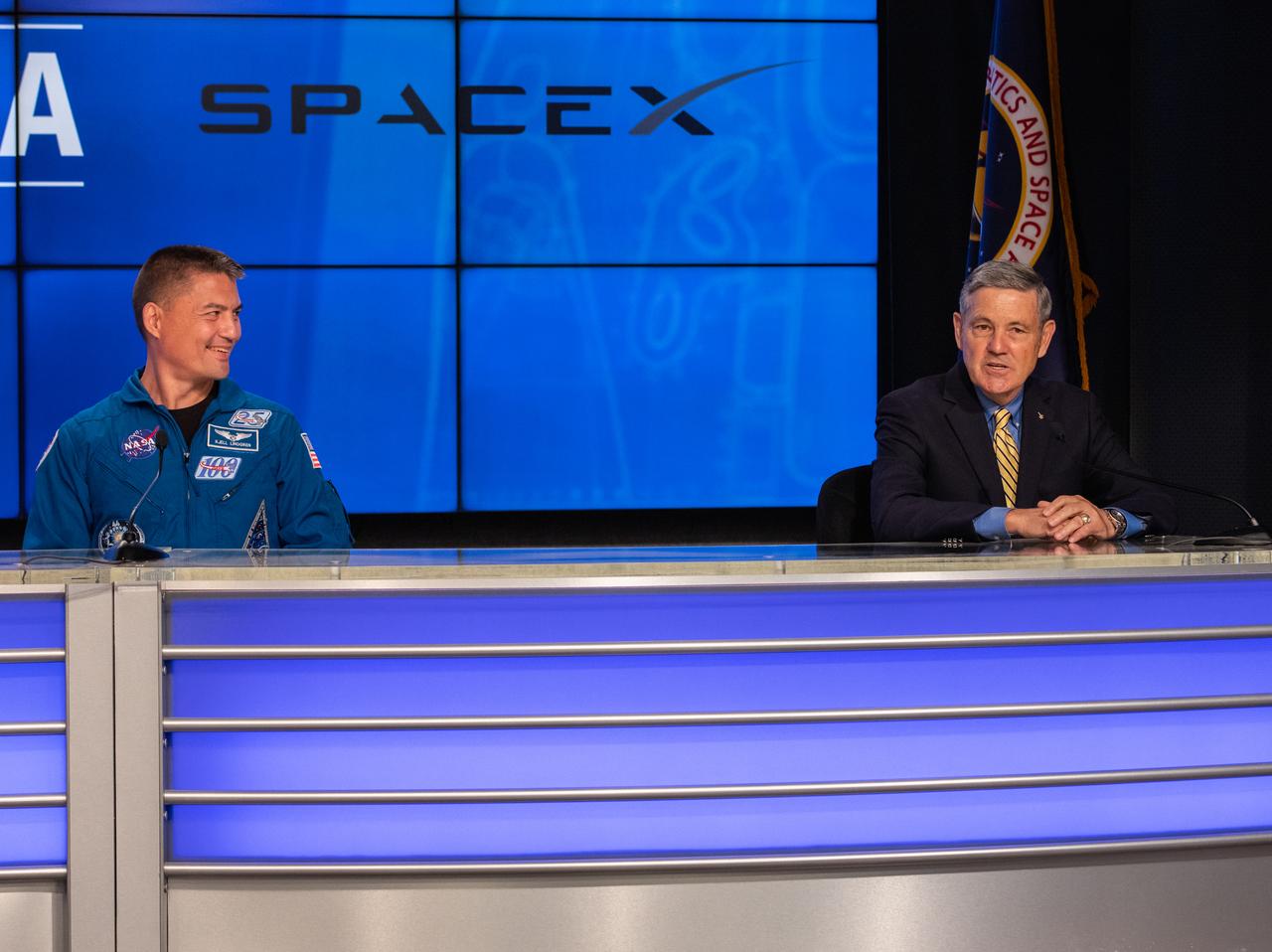 NASA astronaut Kjell Lindgren (left) and Kennedy Space Center Director Bob Cabana participate in a NASA Social Facebook Live briefing inside the Press Site auditorium on May 26, 2020, at Kennedy ahead of NASA’s SpaceX Demo-2 launch, slated for Wednesday, May 27. A SpaceX Falcon 9 rocket and Crew Dragon spacecraft are scheduled to lift off from Kennedy’s Launch Complex 39A, carrying NASA astronauts Robert Behnken and Douglas Hurley to the International Space Station. This will mark the first launch of astronauts from U.S. soil to the space station since the conclusion of the Space Shuttle Program in 2011. Part of the agency’s Commercial Crew Program, this will be SpaceX’s final flight test, paving the way for NASA to certify the crew transportation system for regular, crewed flights to the orbiting laboratory. Liftoff is scheduled for 4:33 p.m. EDT.