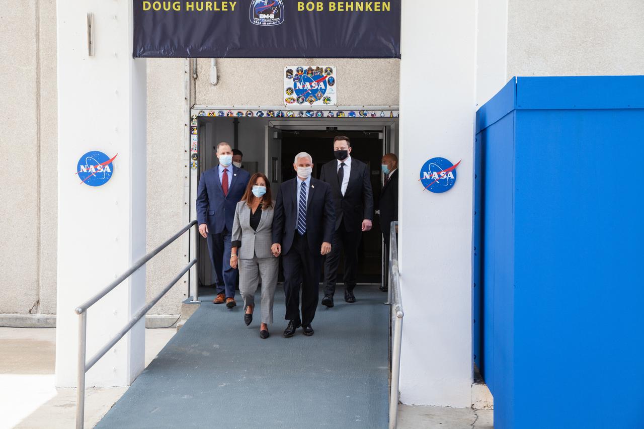 Second lady Karen Pence (left) and Vice President Mike Pence exit the Neil A. Armstrong Operations and Checkout Building at the agency’s Kennedy Space Center in Florida ahead of NASA’s SpaceX Demo-2 launch. Behind them are NASA Administrator Jim Bridenstine (left) and SpaceX CEO and Chief Designer Elon Musk. The launch, initially scheduled for May 27, 2020, was scrubbed due to unfavorable weather conditions around Launch Complex 39A. The next launch attempt will be Saturday, May 30. Liftoff of the SpaceX Falcon 9 rocket and Crew Dragon spacecraft is scheduled for 3:22 p.m. EDT from historic Launch Complex 39A. Behnken and Hurley will be the first astronauts to launch to the International Space Station from U.S. soil since the end of the Space Shuttle Program in 2011. Part of NASA’s Commercial Crew Program, this will be SpaceX’s final flight test, paving the way for the agency to certify the crew transportation system for regular, crewed flights to the orbiting laboratory.