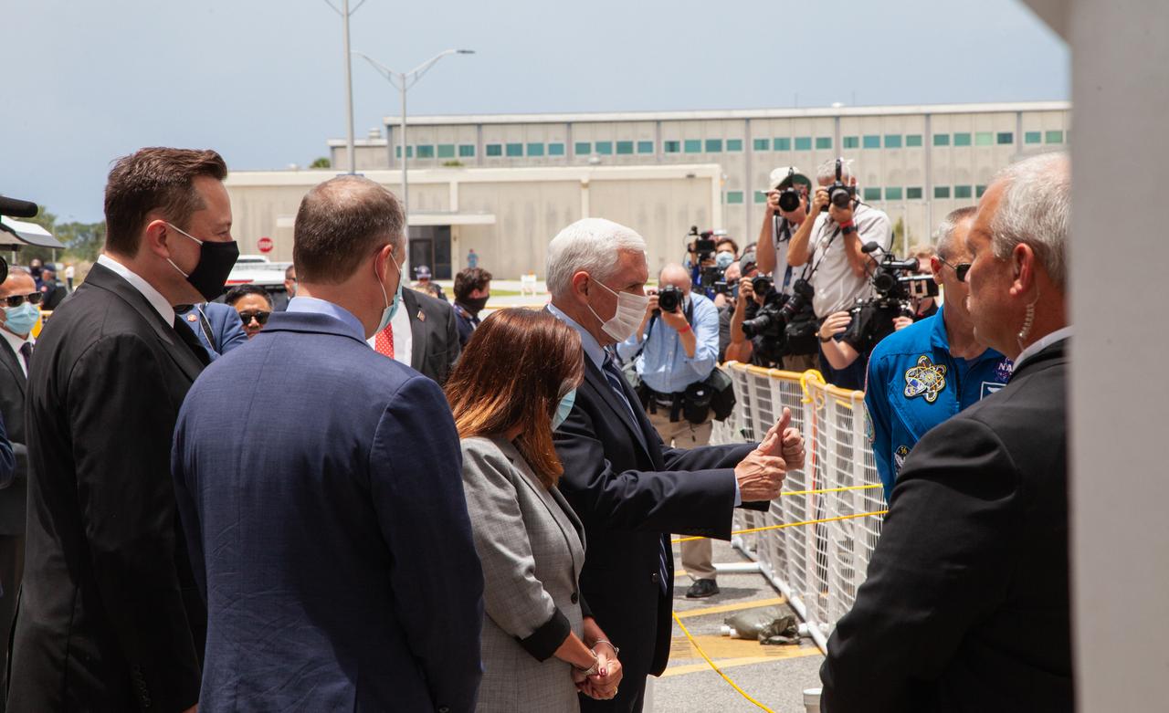 From left, SpaceX CEO and Chief Designer Elon Musk, NASA Administrator Jim Bridenstine, second lady Karen Pence and Vice President Mike Pence wait to greet NASA astronauts Robert Behnken and Douglas Hurley outside of the Neil A. Armstrong Operations and Checkout Building at the agency’s Kennedy Space Center in Florida ahead of NASA’s SpaceX Demo-2 launch. The launch, initially scheduled for May 27, 2020, was scrubbed due to unfavorable weather conditions around Launch Complex 39A. The next launch attempt will be Saturday, May 30. Liftoff of the SpaceX Falcon 9 rocket and Crew Dragon spacecraft is scheduled for 3:22 p.m. EDT from historic Launch Complex 39A. Behnken and Hurley will be the first astronauts to launch to the International Space Station from U.S. soil since the end of the Space Shuttle Program in 2011. Part of NASA’s Commercial Crew Program, this will be SpaceX’s final flight test, paving the way for the agency to certify the crew transportation system for regular, crewed flights to the orbiting laboratory.