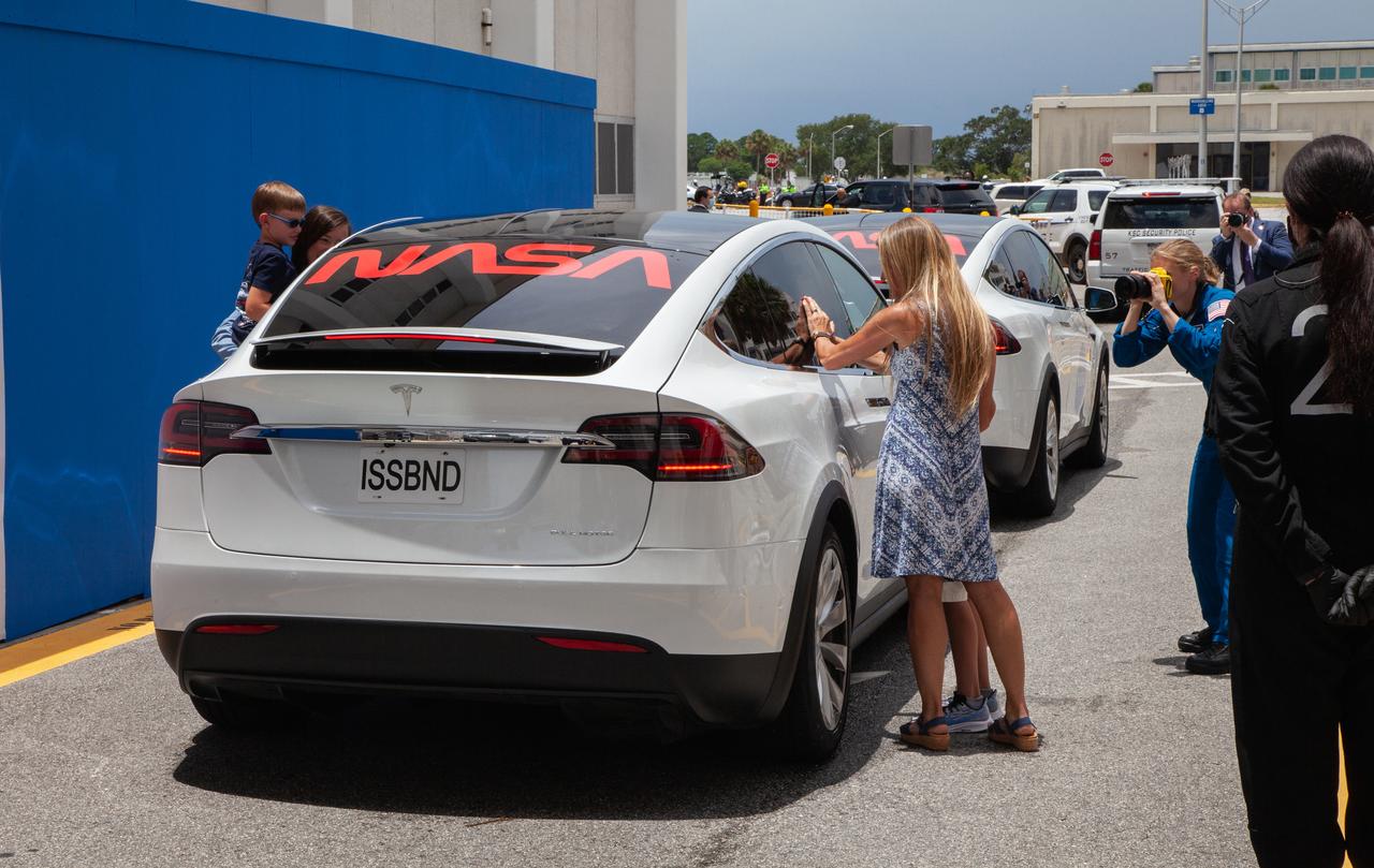 After NASA astronauts Robert Behnken and Douglas Hurley enter the Tesla Model X that will transport them from the Neil A. Armstrong Operations and Checkout Building to historic Launch Complex 39A at the Kennedy Space Center in Florida, their families approach the car to give their goodbyes ahead of the agency’s SpaceX Demo-2 mission. The launch, initially scheduled for May 27, 2020, was scrubbed due to unfavorable weather conditions around Launch Complex 39A. The next launch attempt will be Saturday, May 30. Liftoff of the SpaceX Falcon 9 rocket and Crew Dragon spacecraft is scheduled for 3:22 p.m. EDT from historic Launch Complex 39A. Behnken and Hurley will be the first astronauts to launch to the International Space Station from U.S. soil since the end of the Space Shuttle Program in 2011. Part of NASA’s Commercial Crew Program, this will be SpaceX’s final flight test, paving the way for the agency to certify the crew transportation system for regular, crewed flights to the orbiting laboratory.