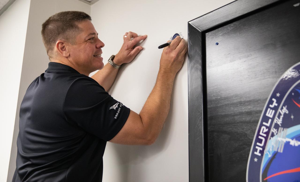 NASA astronaut Robert Behnken adds his signature to a wall inside the Astronaut Crew Quarters in the Neil A. Armstrong Operations and Checkout Building at the agency’s Kennedy Space Center in Florida ahead of NASA’s SpaceX Demo-2 mission. The launch, initially scheduled for May 27, 2020, was scrubbed due to unfavorable weather conditions around Launch Complex 39A. The next launch attempt will be Saturday, May 30. Liftoff of the SpaceX Falcon 9 rocket and Crew Dragon spacecraft is scheduled for 3:22 p.m. EDT from historic Launch Complex 39A. Behnken and crewmate Douglas Hurley will be the first astronauts to launch to the International Space Station from U.S. soil since the end of the Space Shuttle Program in 2011. Part of NASA’s Commercial Crew Program, this will be SpaceX’s final flight test, paving the way for the agency to certify the crew transportation system for regular, crewed flights to the orbiting laboratory.