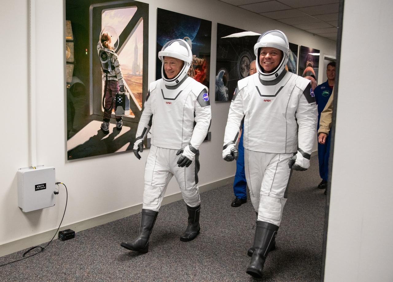 NASA astronauts Douglas Hurley (left) and Robert Behnken depart the Neil A. Armstrong Operations and Checkout Building at the agency’s Kennedy Space Center in Florida on May 27, 2020, in preparation for transport to Launch Complex 39A ahead of NASA’s SpaceX Demo-2 mission. The launch was scrubbed due to unfavorable weather conditions around Launch Complex 39A, and the next launch attempt will be Saturday, May 30. Liftoff of the SpaceX Falcon 9 rocket and Crew Dragon spacecraft is scheduled for 3:22 p.m. EDT from historic Launch Complex 39A. Behnken and Hurley will be the first astronauts to launch to the International Space Station from U.S. soil since the end of the Space Shuttle Program in 2011. Part of NASA’s Commercial Crew Program, this will be SpaceX’s final flight test, paving the way for the agency to certify the crew transportation system for regular, crewed flights to the orbiting laboratory.
