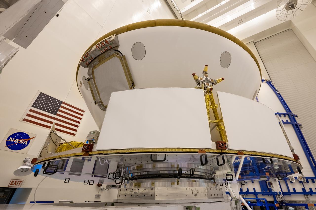 Inside the Payload Hazardous Servicing Facility at NASA’s Kennedy Space Center in Florida, the Backshell-Powered Descent Vehicle and Entry Vehicle assemblies are being attached to the Mars Perseverance rover on May 29, 2020. The cone-shaped backshell contains the parachute, and along with the mission’s heat shield, provides protection for the rover and descent stage during Martian atmospheric entry. The Mars Perseverance rover is scheduled to launch on July 20 atop a United Launch Alliance Atlas V 541 rocket from Pad 41 at nearby Cape Canaveral Air Force Station. The rover is part of NASA’s Mars Exploration Program, a long-term effort of robotic exploration of the Red Planet. The rover will search for habitable conditions in the ancient past and signs of past microbial life on Mars. The Launch Services Program at Kennedy is responsible for launch management.