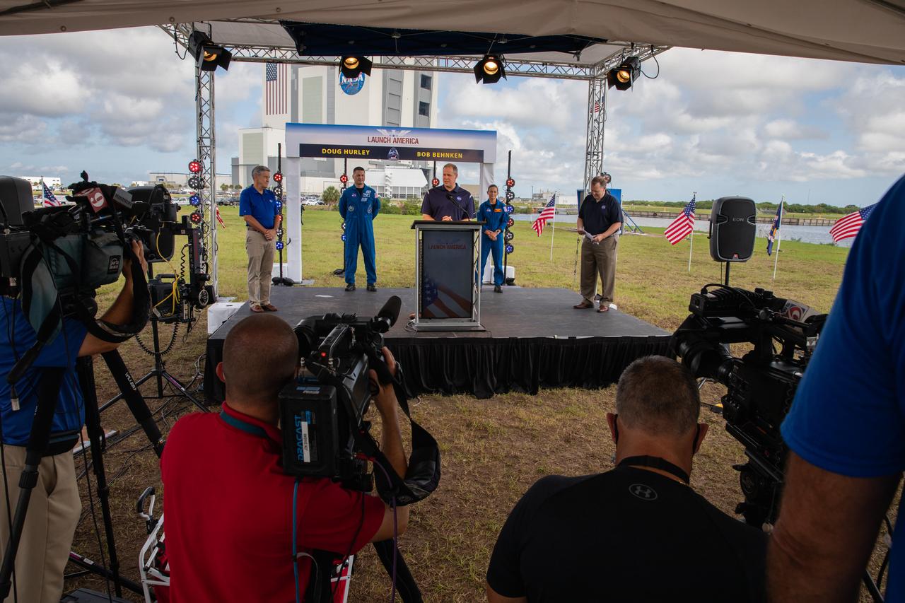 NASA Administrator Jim Bridenstine speaks to members of the media during a press briefing May 29, 2020, near the Press Site countdown clock at the agency’s Kennedy Space Center in Florida ahead of NASA’s SpaceX Demo-2 launch. Behind him are Kennedy Space Center Director Bob Cabana (far left), NASA astronauts Kjell Lindgren and Nicole Mann, and NASA Deputy Administrator Jim Morhard (far right). The launch, initially scheduled for May 27, was scrubbed due to unfavorable weather conditions. The next launch attempt is Saturday, May 30. A SpaceX Falcon 9 rocket and Crew Dragon spacecraft are scheduled to lift off from Kennedy’s Launch Complex 39A, carrying NASA astronauts Robert Behnken and Douglas Hurley to the International Space Station. This will mark the first launch of astronauts from U.S. soil to the space station since the conclusion of the Space Shuttle Program in 2011. Part of the agency’s Commercial Crew Program, this will be SpaceX’s final flight test, paving the way for NASA to certify the crew transportation system for regular, crewed flights to the orbiting laboratory. Liftoff is scheduled for 3:22 p.m. EDT.