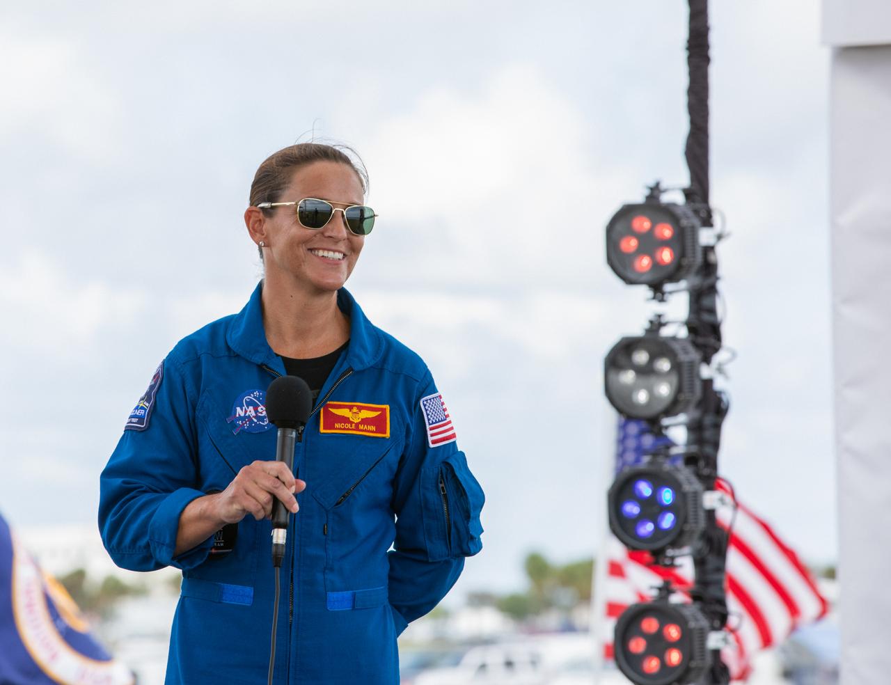 NASA astronaut Nicole Mann participates in a NASA Social YouTube Live briefing May 29, 2020, near the Press Site countdown clock at the agency’s Kennedy Space Center in Florida ahead of NASA’s SpaceX Demo-2 launch. The launch, initially scheduled for May 27, was scrubbed due to unfavorable weather conditions. The next launch attempt is Saturday, May 30. A SpaceX Falcon 9 rocket and Crew Dragon spacecraft are scheduled to lift off from Kennedy’s Launch Complex 39A, carrying NASA astronauts Robert Behnken and Douglas Hurley to the International Space Station. This will mark the first launch of astronauts from U.S. soil to the space station since the conclusion of the Space Shuttle Program in 2011. Part of the agency’s Commercial Crew Program, this will be SpaceX’s final flight test, paving the way for NASA to certify the crew transportation system for regular, crewed flights to the orbiting laboratory. Liftoff is scheduled for 3:22 p.m. EDT.
