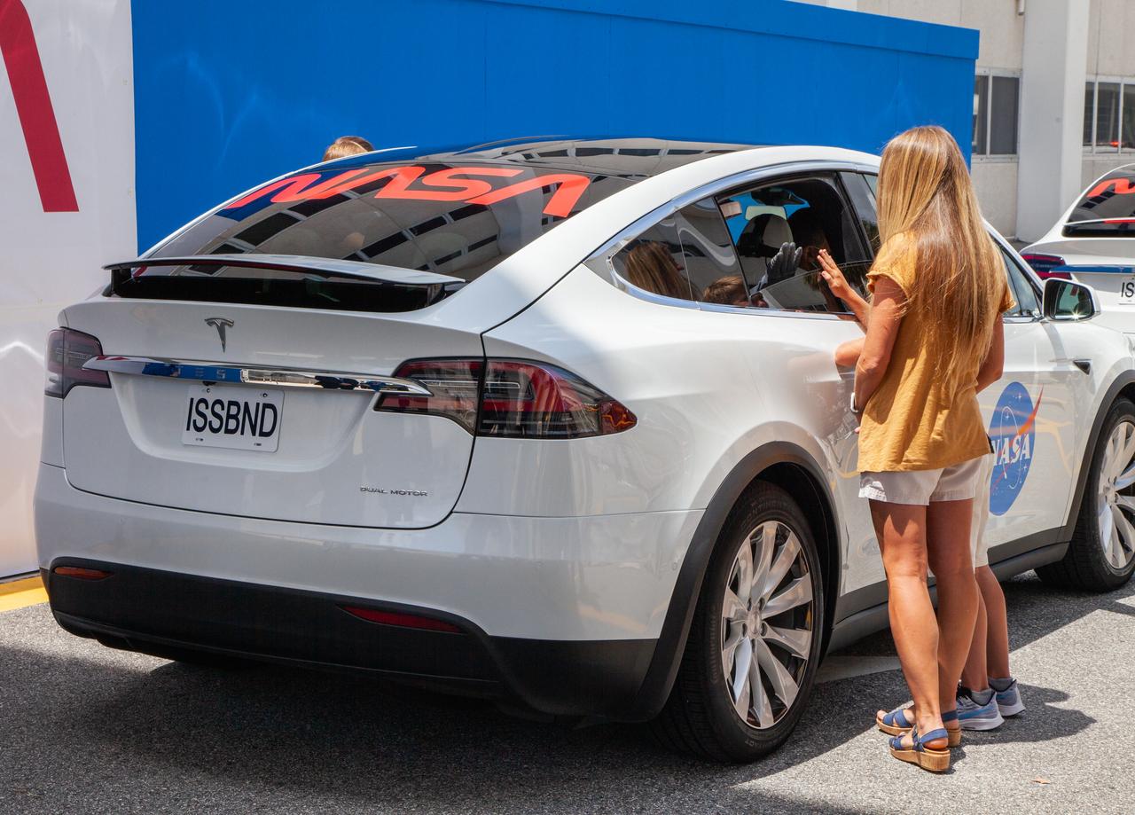 After NASA astronauts Robert Behnken and Douglas Hurley enter the Tesla Model X that will transport them from the Neil A. Armstrong Operations and Checkout Building to historic Launch Complex 39A at the Kennedy Space Center in Florida, their families approach the car to give their goodbyes ahead of the agency’s SpaceX Demo-2 mission on May 30, 2020. Liftoff of the SpaceX Falcon 9 rocket and Crew Dragon spacecraft occurred at 3:22 p.m. EDT. Behnken and Hurley are the first astronauts to launch to the International Space Station from U.S. soil since the end of the Space Shuttle Program in 2011. Part of NASA’s Commercial Crew Program, this will be SpaceX’s final flight test, paving the way for the agency to certify the crew transportation system for regular, crewed flights to the orbiting laboratory.