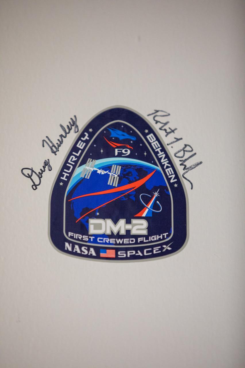 A photograph is taken of the signatures, along with the agency’s SpaceX Demo-2 mission patch, NASA astronauts Robert Behnken and Douglas Hurley added to a wall inside the Astronaut Crew Quarters in the Neil A. Armstrong Operations and Checkout Building at the agency’s Kennedy Space Center in Florida ahead of the Demo-2 launch on May 30, 2020. The SpaceX Falcon 9 rocket and Crew Dragon spacecraft lifted off at 3:22 p.m. EDT from historic Launch Complex 39A. Behnken and Hurley are the first astronauts to launch to the International Space Station from U.S. soil since the end of the Space Shuttle Program in 2011. Part of NASA’s Commercial Crew Program, this will be SpaceX’s final flight test, paving the way for the agency to certify the crew transportation system for regular, crewed flights to the orbiting laboratory.