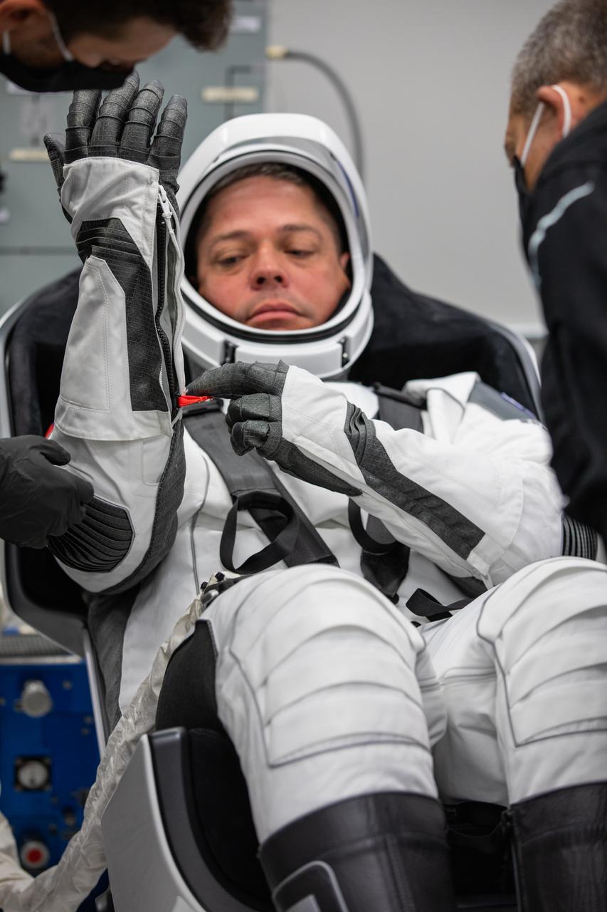 Inside the suit-up room in the Neil A. Armstrong Operations and Checkout Building at NASA’s Kennedy Space Center in Florida, NASA astronaut Robert Behnken dons his spacesuit ahead of the agency’s SpaceX Demo-2 launch on May 30, 2020. Behnken and crewmate Douglas Hurley are the first astronauts to launch to the International Space Station from U.S. soil since the end of the Space Shuttle Program in 2011. The SpaceX Falcon 9 rocket and Crew Dragon spacecraft lifted off at 3:22 p.m. EDT from historic Launch Complex 39A. Part of NASA’s Commercial Crew Program, this will be SpaceX’s final flight test, paving the way for the agency to certify the crew transportation system for regular, crewed flights to the orbiting laboratory.