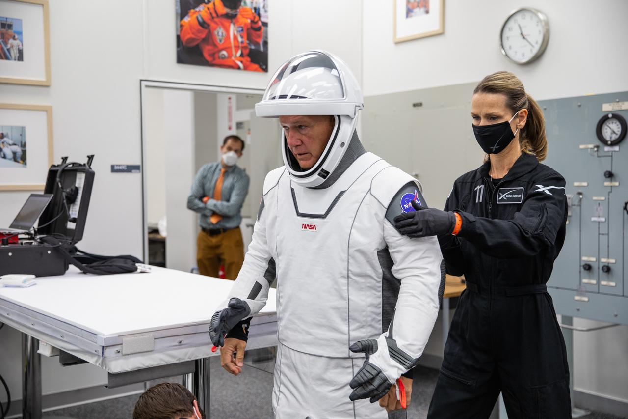 Inside the suit-up room in the Neil A. Armstrong Operations and Checkout Building at NASA’s Kennedy Space Center in Florida, NASA astronaut Douglas Hurley dons his spacesuit ahead of the agency’s SpaceX Demo-2 launch on May 30, 2020. Hurley and crewmate Robert Behnken are the first astronauts to launch to the International Space Station from U.S. soil since the end of the Space Shuttle Program in 2011. The SpaceX Falcon 9 rocket and Crew Dragon spacecraft lifted off at 3:22 p.m. EDT from historic Launch Complex 39A. Part of NASA’s Commercial Crew Program, this will be SpaceX’s final flight test, paving the way for the agency to certify the crew transportation system for regular, crewed flights to the orbiting laboratory.