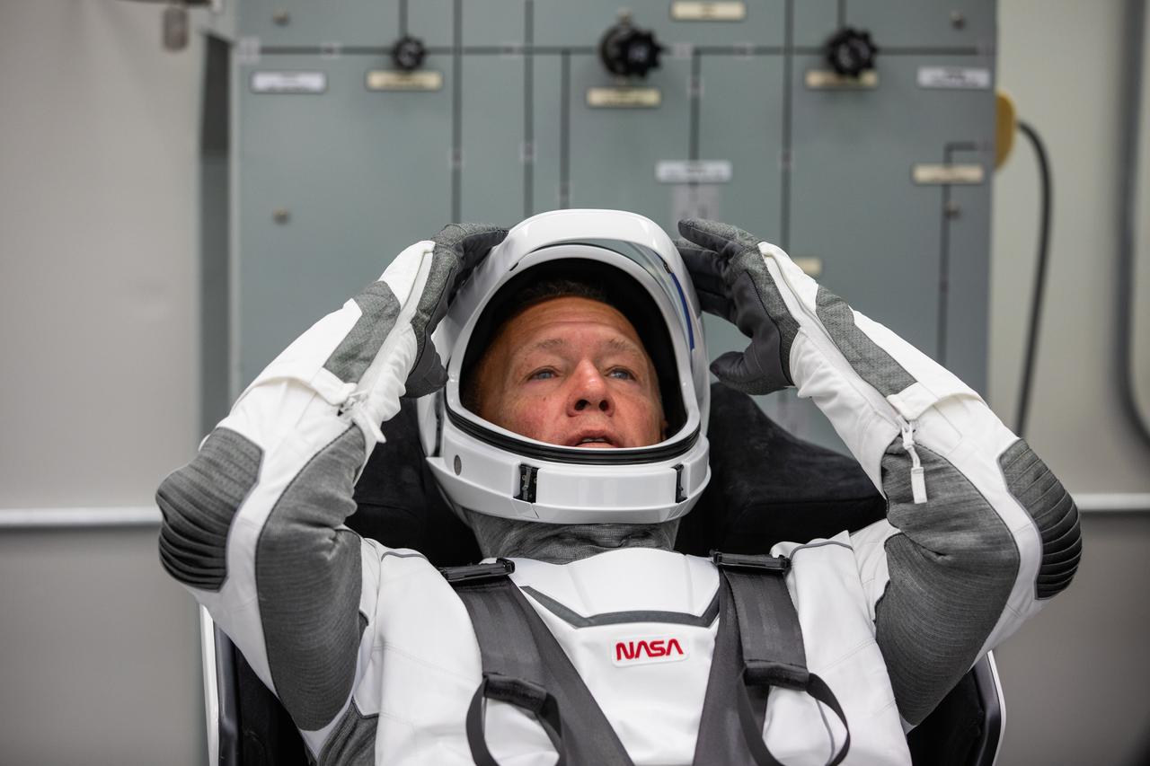 Inside the suit-up room in the Neil A. Armstrong Operations and Checkout Building at NASA’s Kennedy Space Center in Florida, NASA astronaut Douglas Hurley dons his spacesuit ahead of the agency’s SpaceX Demo-2 launch on May 30, 2020. Hurley and crewmate Robert Behnken are the first astronauts to launch to the International Space Station from U.S. soil since the end of the Space Shuttle Program in 2011. The SpaceX Falcon 9 rocket and Crew Dragon spacecraft lifted off at 3:22 p.m. EDT from historic Launch Complex 39A. Part of NASA’s Commercial Crew Program, this will be SpaceX’s final flight test, paving the way for the agency to certify the crew transportation system for regular, crewed flights to the orbiting laboratory.