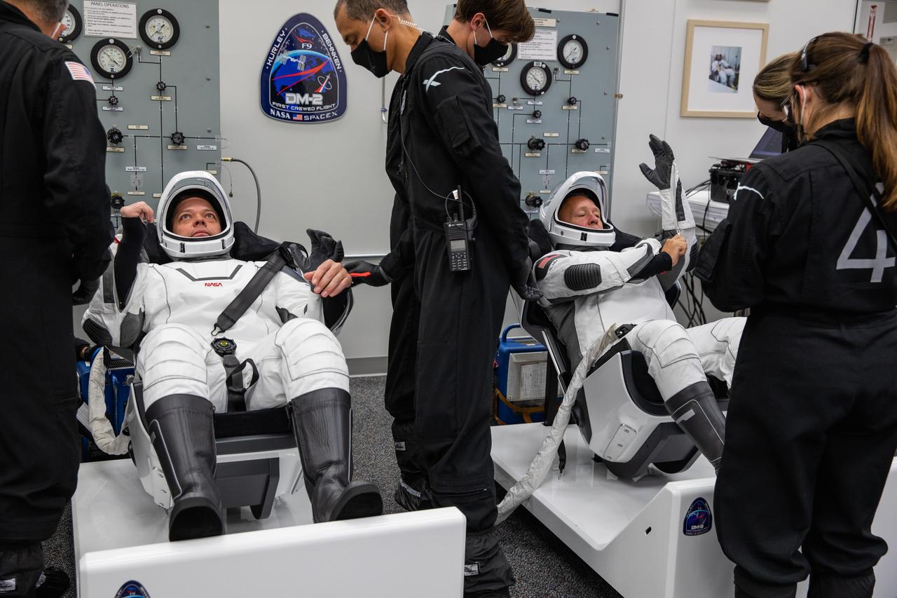 Inside the suit-up room in the Neil A. Armstrong Operations and Checkout Building at NASA’s Kennedy Space Center in Florida, NASA astronauts Robert Behnken (left) and Douglas Hurley don their spacesuits ahead of the agency’s SpaceX Demo-2 launch on May 30, 2020. Behnken and Hurley are the first astronauts to launch to the International Space Station from U.S. soil since the end of the Space Shuttle Program in 2011. The SpaceX Falcon 9 rocket and Crew Dragon spacecraft lifted off at 3:22 p.m. EDT from historic Launch Complex 39A. Part of NASA’s Commercial Crew Program, this will be SpaceX’s final flight test, paving the way for the agency to certify the crew transportation system for regular, crewed flights to the orbiting laboratory.
