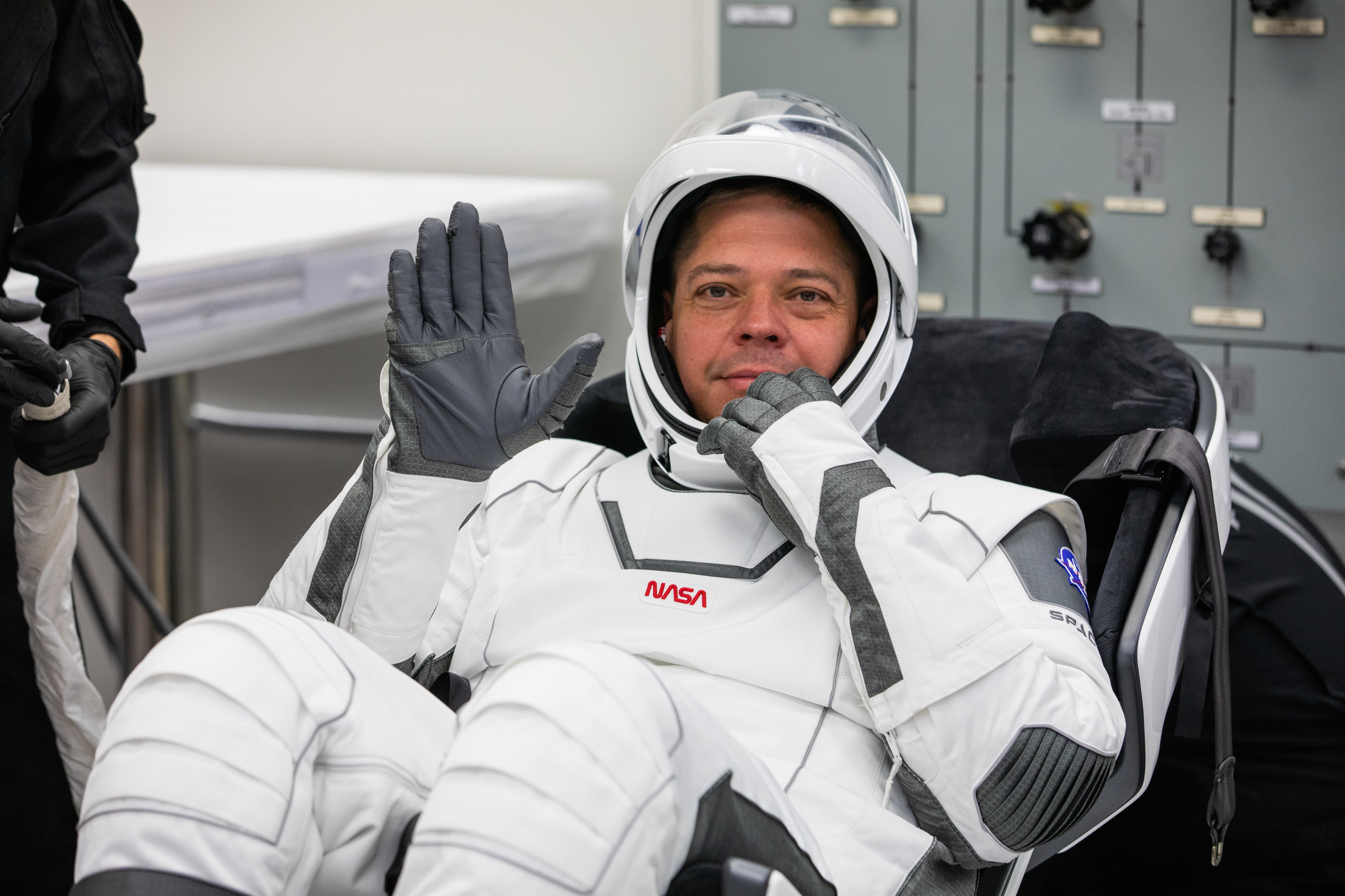 Inside the suit-up room in the Neil A. Armstrong Operations and Checkout Building at NASA’s Kennedy Space Center in Florida, NASA astronaut Robert Behnken waves after donning his spacesuit ahead of the agency’s SpaceX Demo-2 launch on May 30, 2020. Behnken and crewmate Douglas Hurley are the first astronauts to launch to the International Space Station from U.S. soil since the end of the Space Shuttle Program in 2011. The SpaceX Falcon 9 rocket and Crew Dragon spacecraft lifted off at 3:22 p.m. EDT from historic Launch Complex 39A. Part of NASA’s Commercial Crew Program, this will be SpaceX’s final flight test, paving the way for the agency to certify the crew transportation system for regular, crewed flights to the orbiting laboratory.