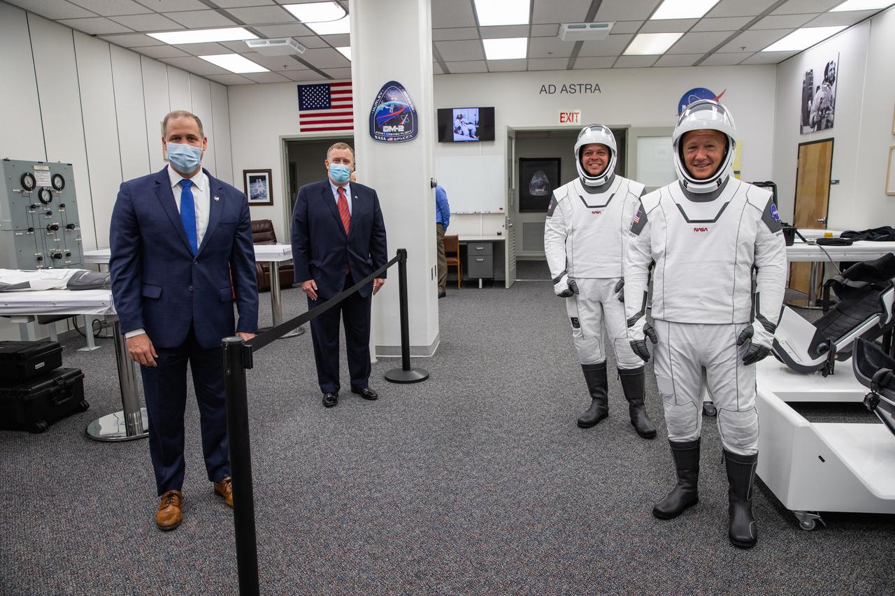 Behind the rope, NASA Administrator Jim Bridenstine (left) and Deputy Administrator Jim Morhard pause for a photo with NASA astronauts Robert Behnken (left) and Douglas Hurley inside the Astronaut Crew Quarters in the Neil A. Armstrong Operations and Checkout Building at NASA’s Kennedy Space Center in Florida on May 30, 2020, ahead of the agency’s SpaceX Demo-2 mission The SpaceX Falcon 9 rocket and Crew Dragon spacecraft lifted off at 3:22 p.m. EDT from historic Launch Complex 39A. Behnken and Hurley are the first astronauts to launch to the International Space Station from U.S. soil since the end of the Space Shuttle Program in 2011. Part of NASA’s Commercial Crew Program, this will be SpaceX’s final flight test, paving the way for the agency to certify the crew transportation system for regular, crewed flights to the orbiting laboratory.