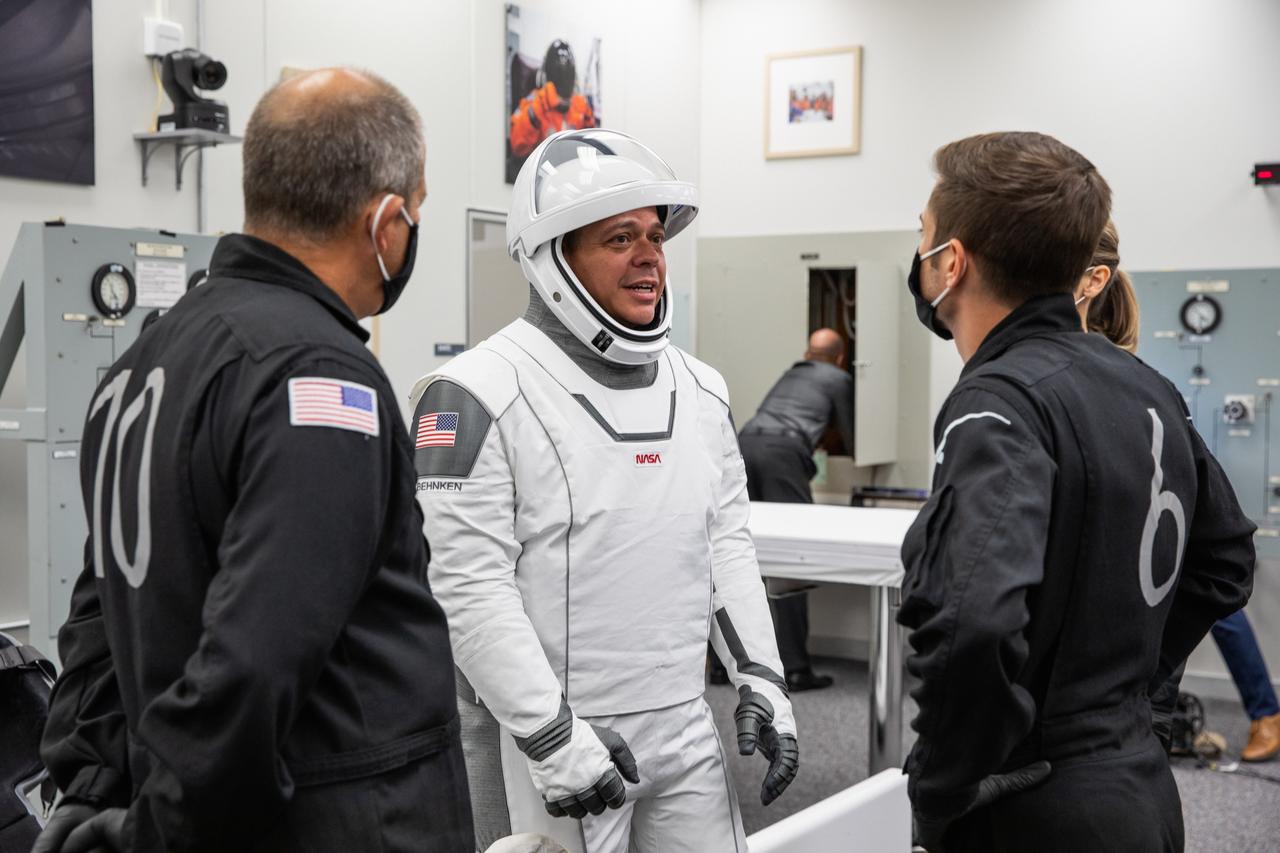 Inside the suit-up room in the Neil A. Armstrong Operations and Checkout Building at NASA’s Kennedy Space Center in Florida, NASA astronaut Robert Behnken dons his spacesuit ahead of the agency’s SpaceX Demo-2 launch on May 30, 2020. Behnken and crewmate Douglas Hurley are the first astronauts to launch to the International Space Station from U.S. soil since the end of the Space Shuttle Program in 2011. The SpaceX Falcon 9 rocket and Crew Dragon spacecraft lifted off at 3:22 p.m. EDT from historic Launch Complex 39A. Part of NASA’s Commercial Crew Program, this will be SpaceX’s final flight test, paving the way for the agency to certify the crew transportation system for regular, crewed flights to the orbiting laboratory.