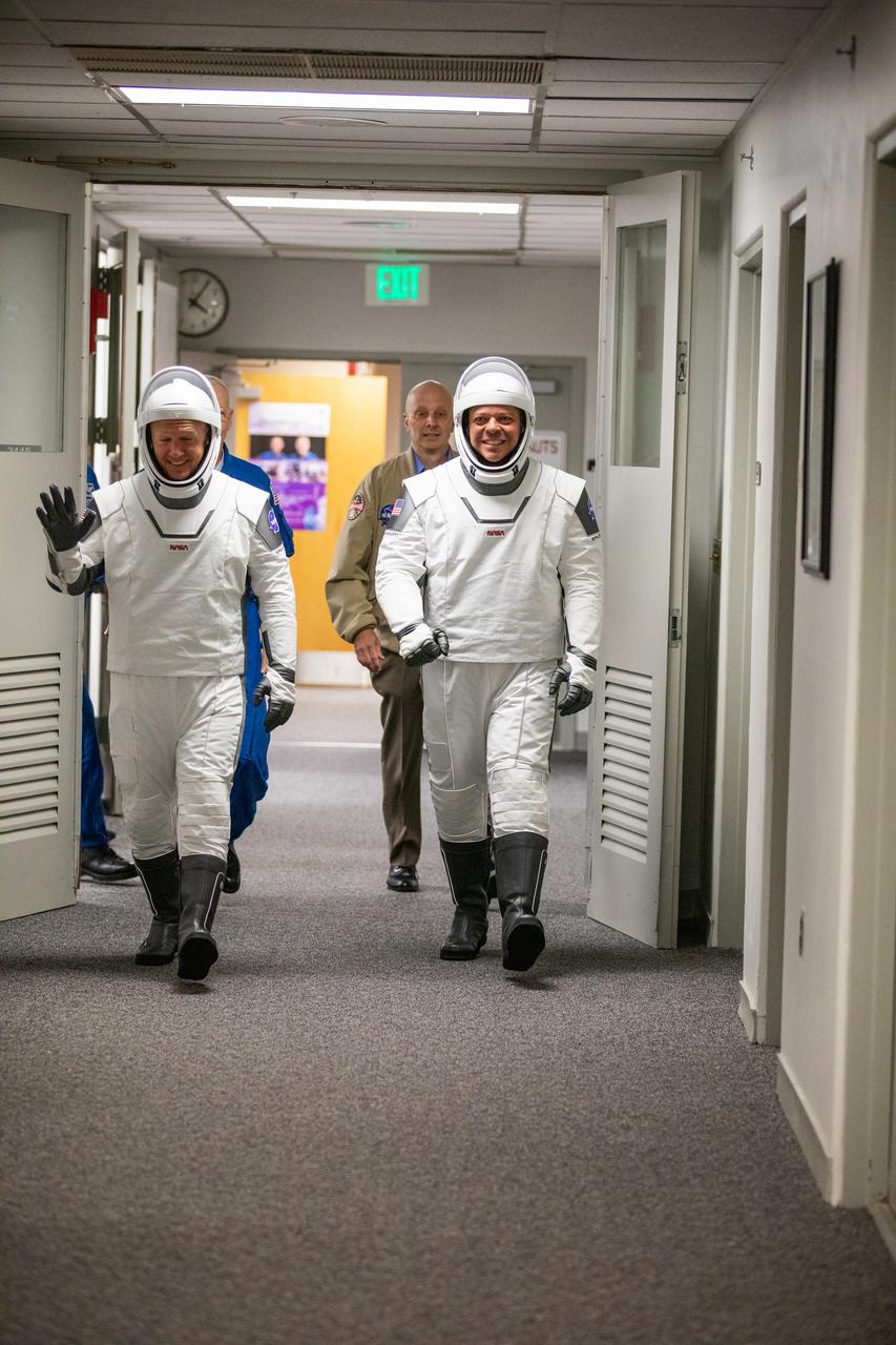 NASA astronauts Douglas Hurley (left) and Robert Behnken prepare to depart the Neil A. Armstrong Operations and Checkout Building at NASA’s Kennedy Space Center in Florida after donning their spacesuits ahead of the agency’s SpaceX Demo-2 launch on May 30, 2020. The SpaceX Falcon 9 rocket and Crew Dragon spacecraft lifted off at 3:22 p.m. EDT from historic Launch Complex 39A. Behnken and Hurley are the first astronauts to launch to the International Space Station from U.S. soil since the end of the Space Shuttle Program in 2011. Part of NASA’s Commercial Crew Program, this will be SpaceX’s final flight test, paving the way for the agency to certify the crew transportation system for regular, crewed flights to the orbiting laboratory.