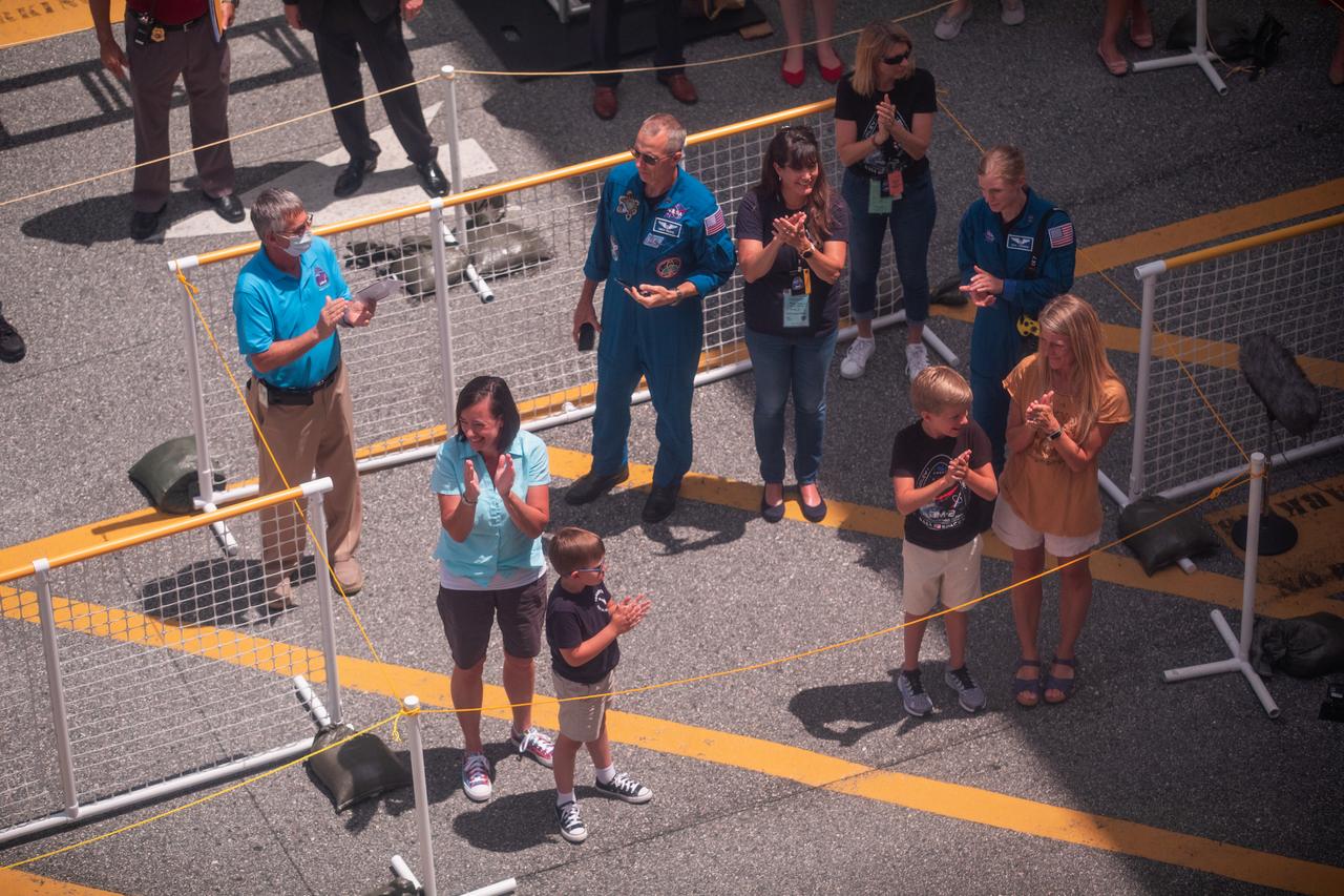 NASA astronauts Robert Behnken’s and Douglas Hurley’s families wait to greet them outside of the Neil A. Armstrong Operations and Checkout Building at the agency’s Kennedy Space Center in Florida ahead of NASA’s SpaceX Demo-2 launch on May 30, 2020. The SpaceX Falcon 9 rocket and Crew Dragon spacecraft lifted off at 3:22 p.m. EDT from historic Launch Complex 39A. Behnken and Hurley are the first astronauts to launch to the International Space Station from U.S. soil since the end of the Space Shuttle Program in 2011. Part of NASA’s Commercial Crew Program, this will be SpaceX’s final flight test, paving the way for the agency to certify the crew transportation system for regular, crewed flights to the orbiting laboratory.