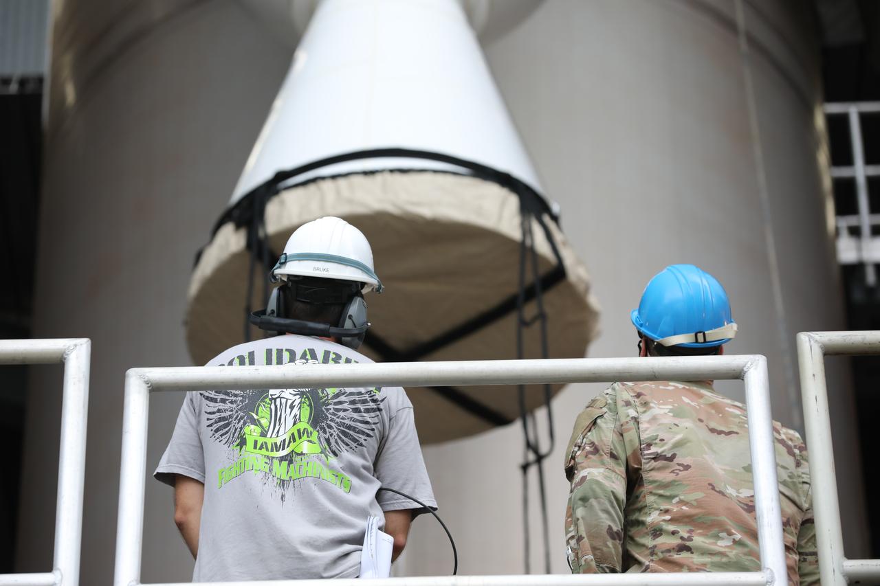 Inside the Vertical Integration Facility at Space Launch Complex 41 at Cape Canaveral Air Force Station in Florida, United Launch Alliance (ULA) workers watch as the second of four solid rocket boosters (SRB) for the ULA Atlas V 541 rocket is lowered by crane into position on June 3, 2020. The SRB will be mated to the Atlas V booster. NASA’s Mars 2020 mission with the Perseverance rover is scheduled to launch on July 20, 2020, atop the Atlas V rocket from Pad 41. The rover is part of NASA’s Mars Exploration Program, a long-term effort of robotic exploration of the Red Planet. The rover’s seven instruments will search for habitable conditions in the ancient past and signs of past microbial life on Mars. The Launch Services Program at Kennedy is responsible for launch management.